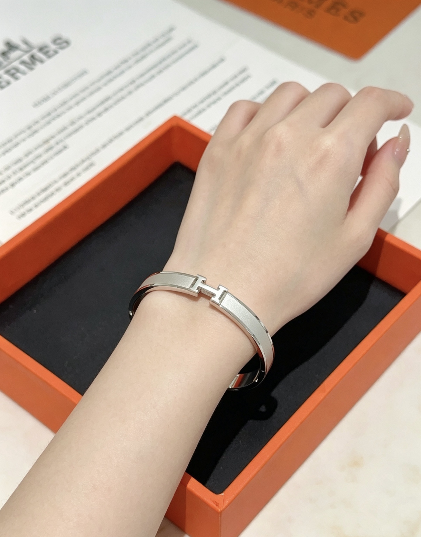 Hermès gold-tone bracelet, shown in the complete original source image set. 6