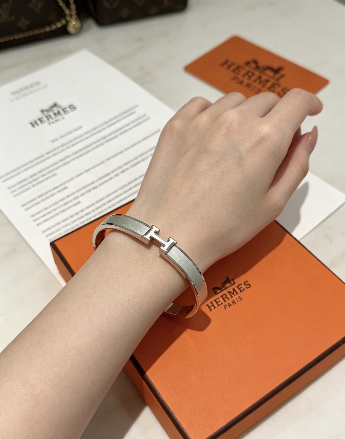 Hermès gold-tone bracelet, shown in the complete original source image set. 3