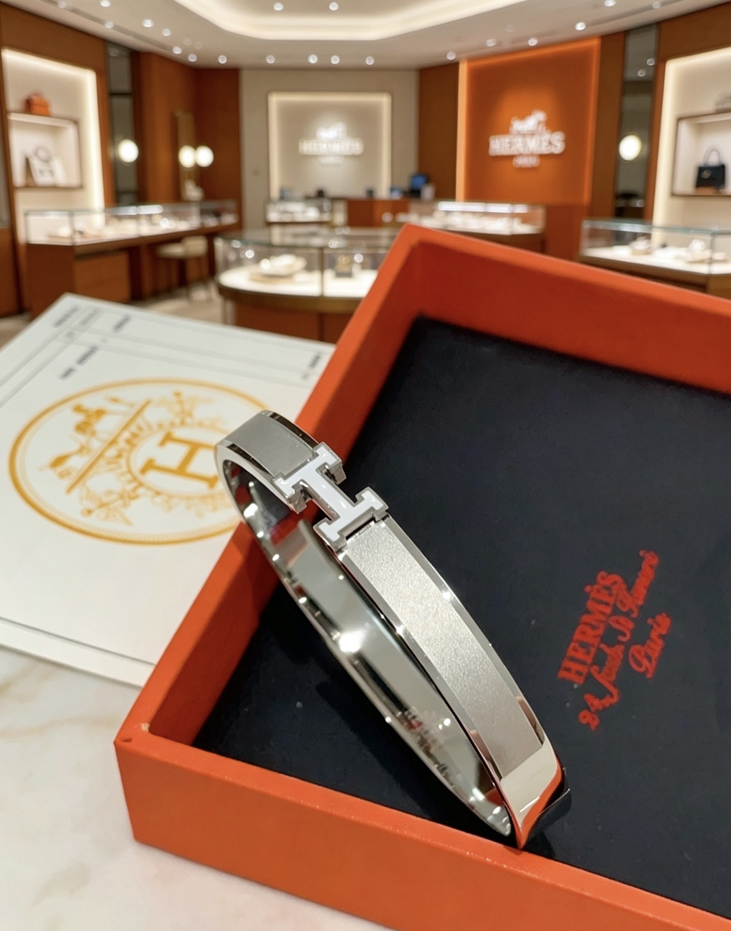 Hermès gold-tone bracelet, shown in the complete original source image set. 9