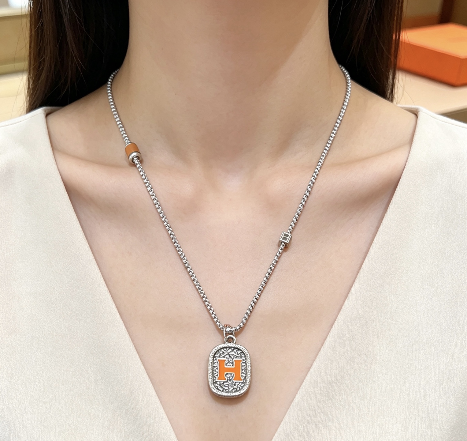 Hermes H Logo Oval Pendant Necklace necklace Silver-toned metal with orange enamel H detail brown leather accent bead 60cm