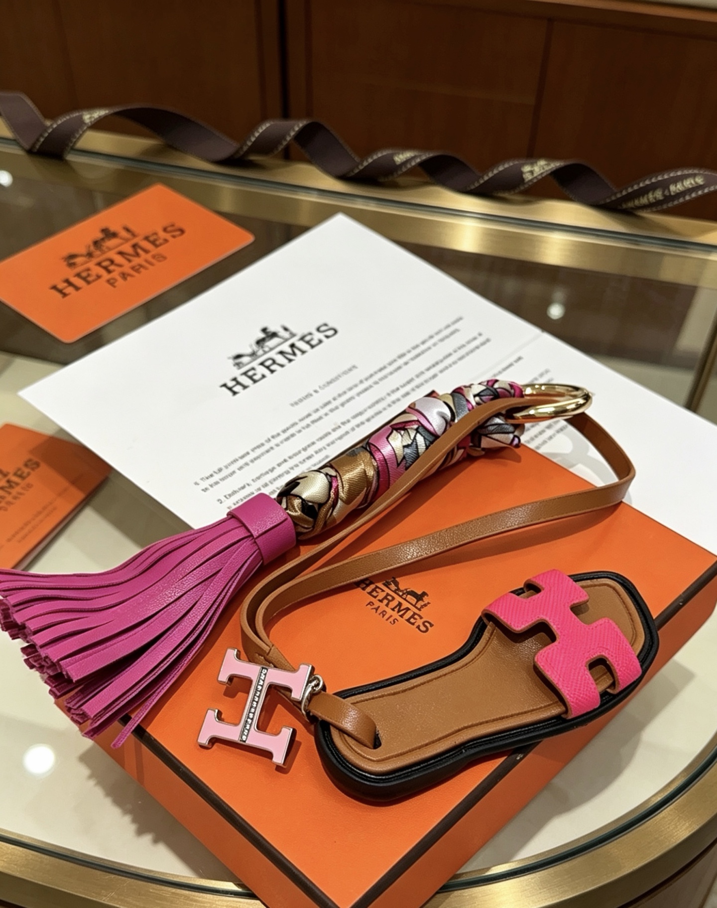 Hermes Oran Sandal Tassel Bag Charm Keychain pendant Gold-tone metal brown leather fuchsia pink leather multicolor silk twill light pink enamel H charm 12cm total length