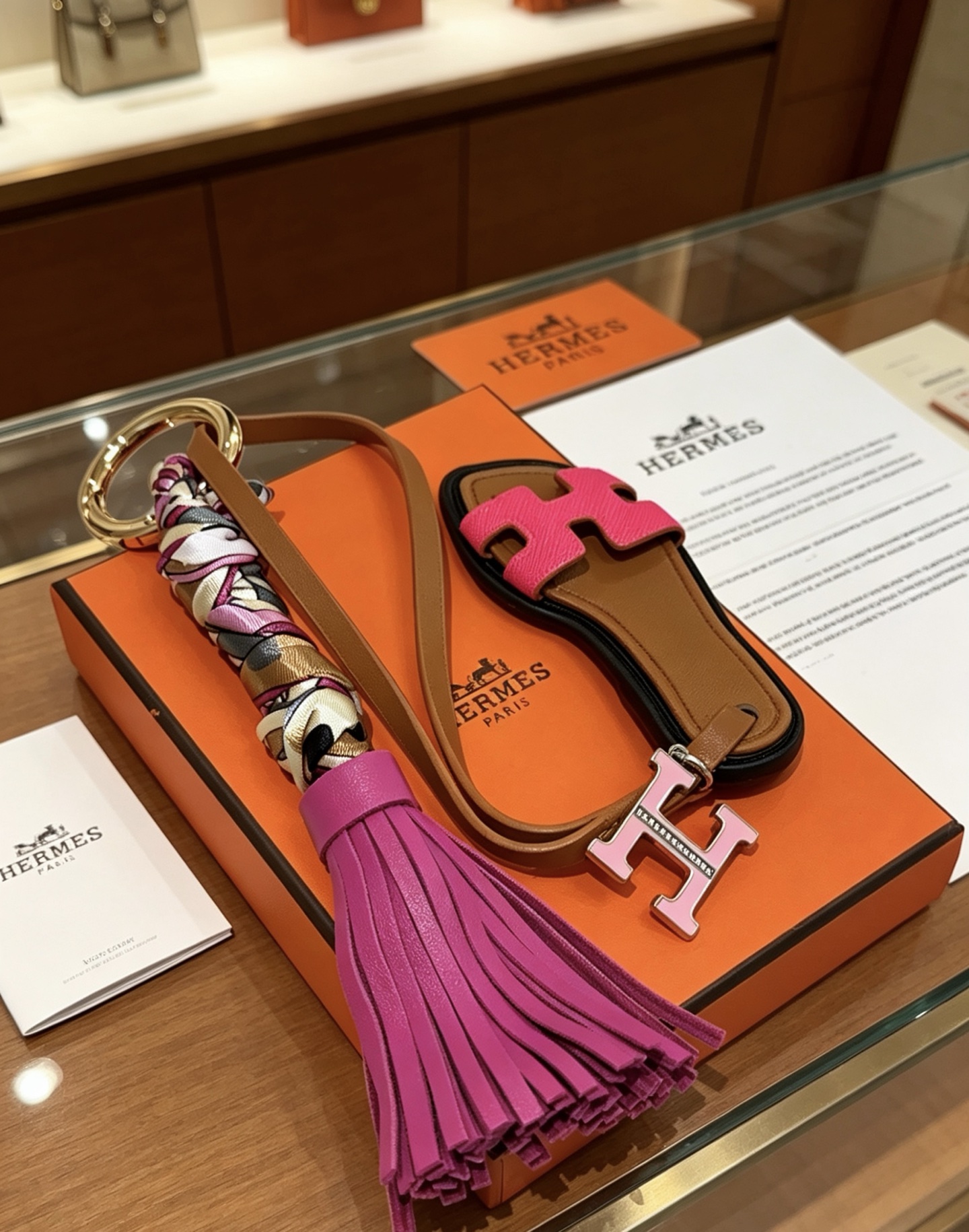 Hermes Oran Sandal Tassel Bag Charm Keychain pendant Gold-tone metal brown leather fuchsia pink leather multicolor silk twill light pink enamel H charm 12cm total length