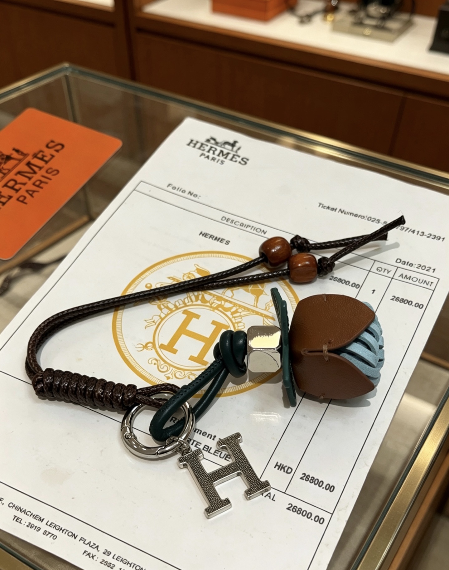Hermes H Logo Leather Acorn Charm Keychain pendant Silver-tone metal dark brown braided leather dark green leather tan leather light blue woven leather brown wooden beads 18cm lanyard length
