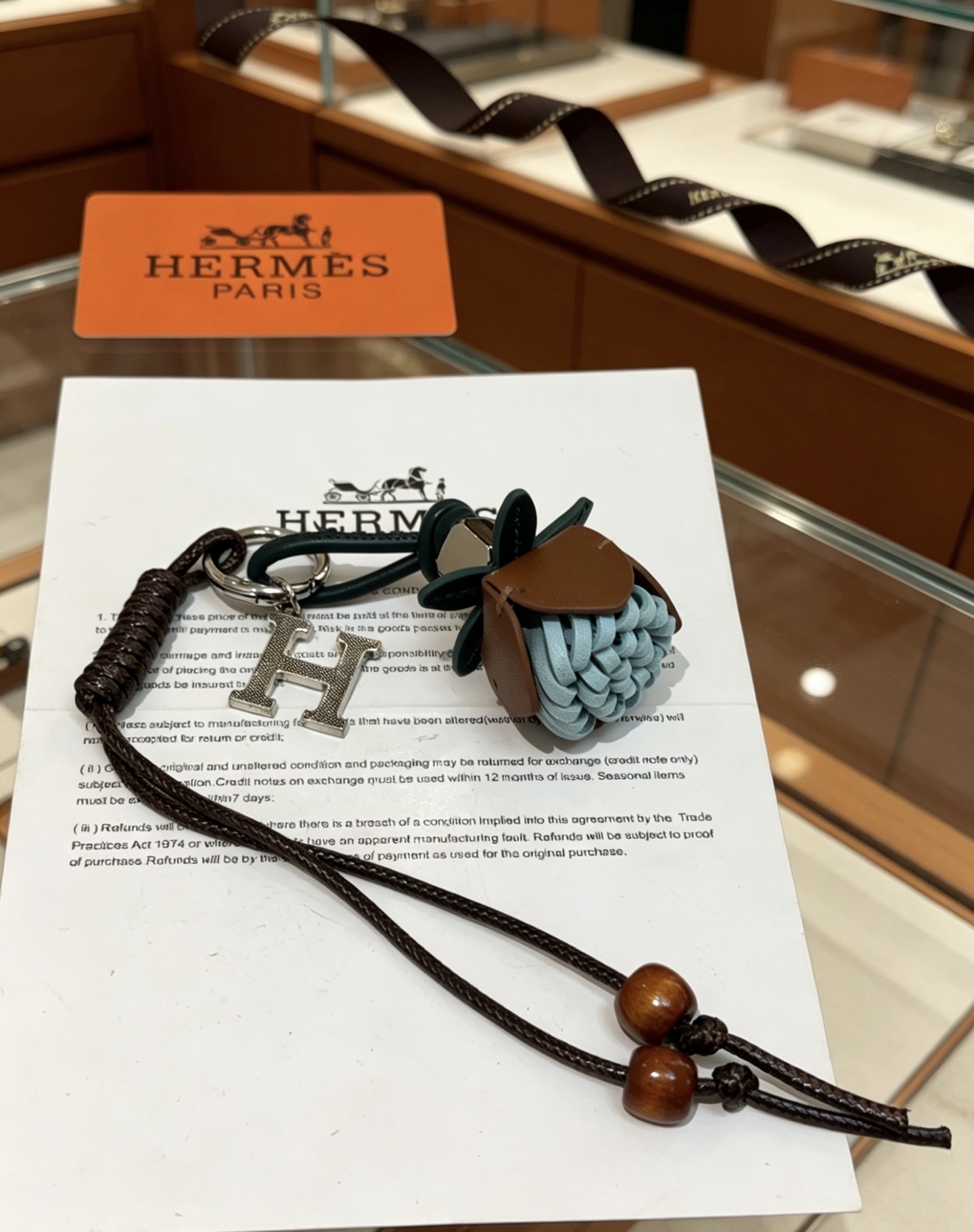 Hermes H Logo Leather Acorn Charm Keychain pendant Silver-tone metal dark brown braided leather dark green leather tan leather light blue woven leather brown wooden beads 18cm lanyard length