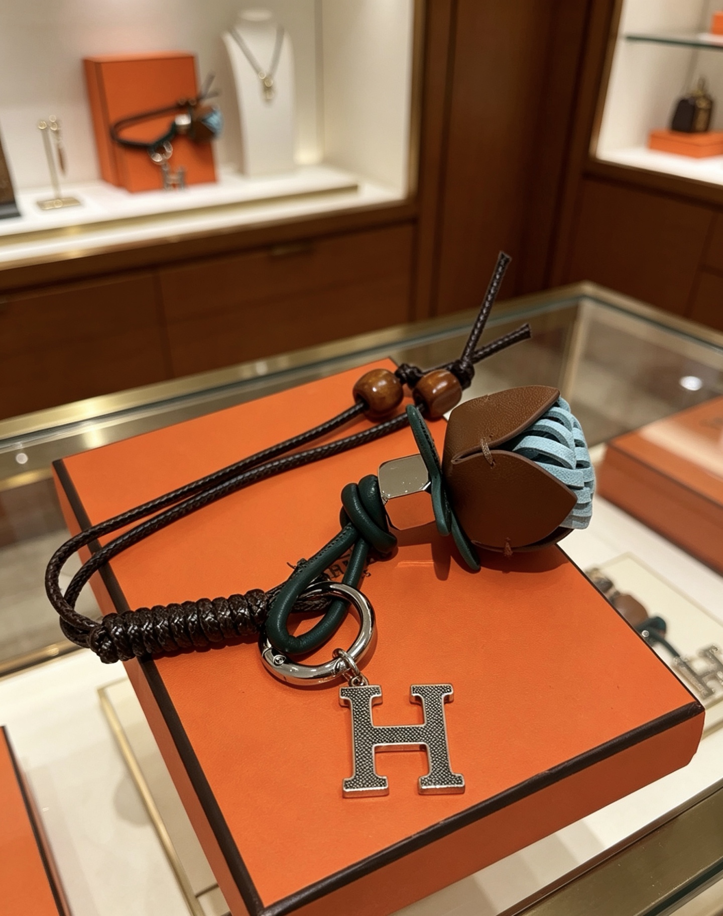Hermes H Logo Leather Acorn Charm Keychain pendant Silver-tone metal dark brown braided leather dark green leather tan leather light blue woven leather brown wooden beads 18cm lanyard length