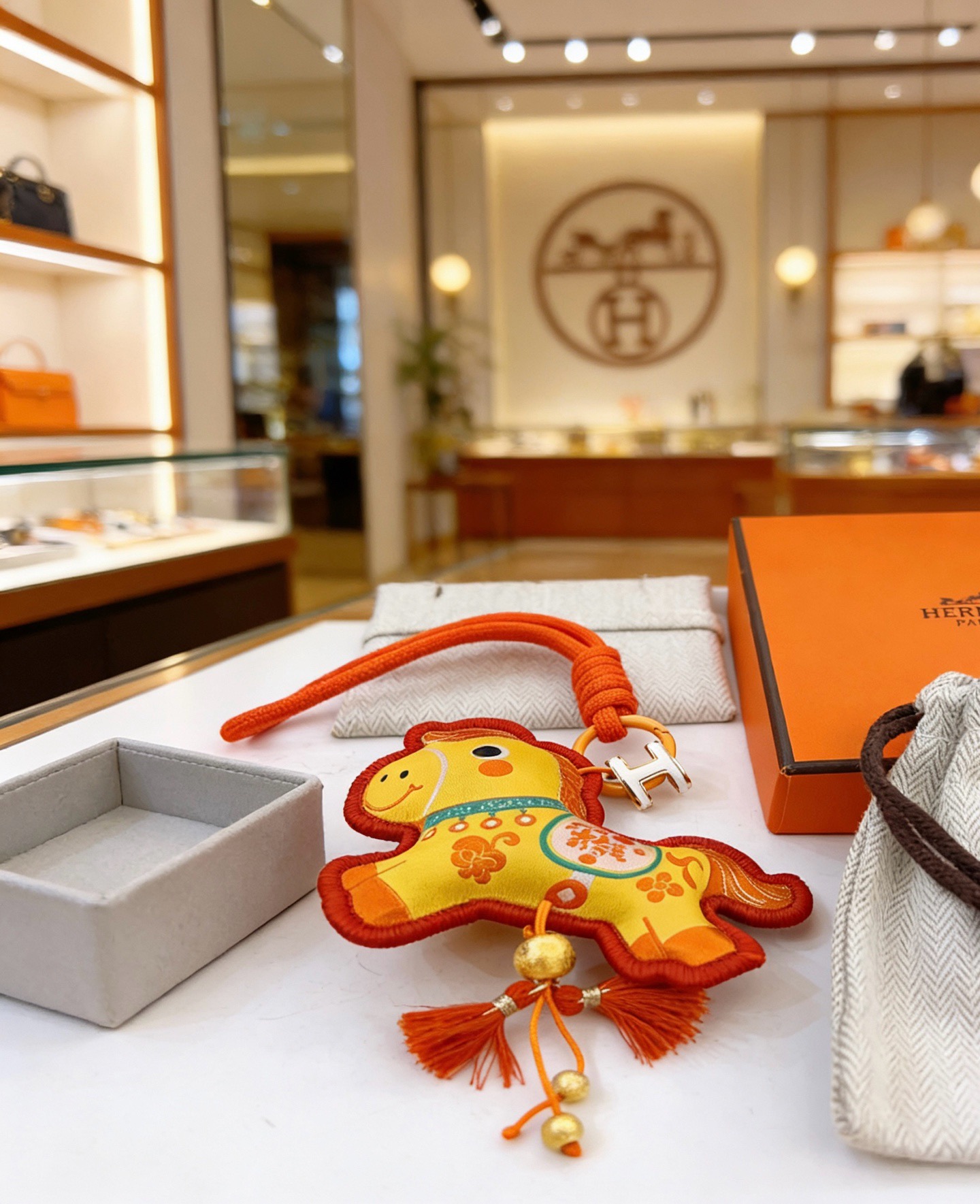 Hermes Year of the Horse Lucky Horse Bag Charm pendant Yellow fabric with red trim orange cord silver-tone H hardware gold-tone bead accents orange and red tassels 12cm total length with strap