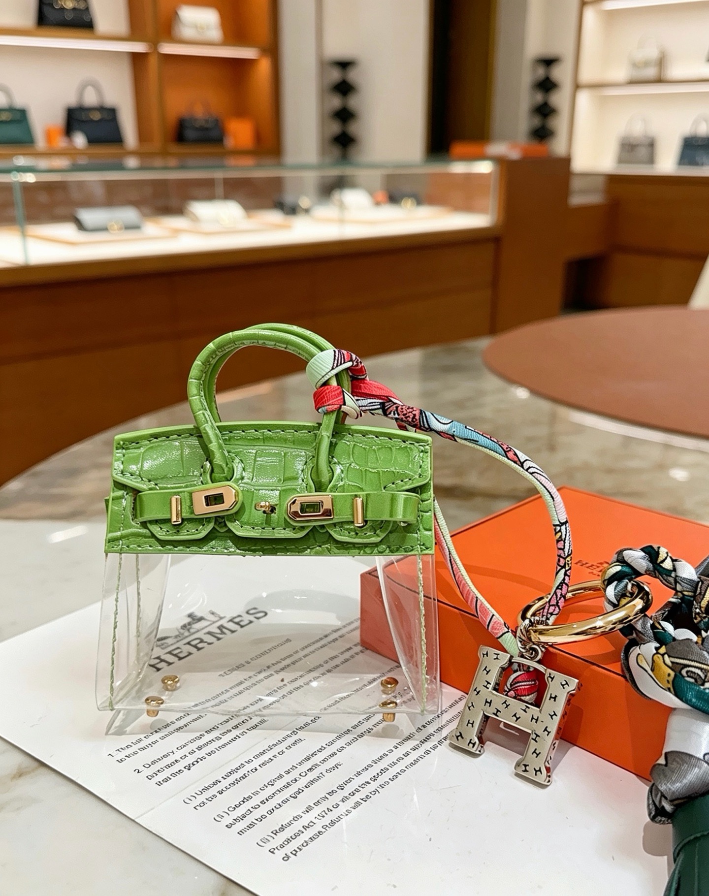 Hermes Birkin Bag Charm Keychain pendant Green crocodile-embossed leather gold-tone metal silver-tone metal multicolor printed silk dark green leather tassel clear vinyl 12cm total length