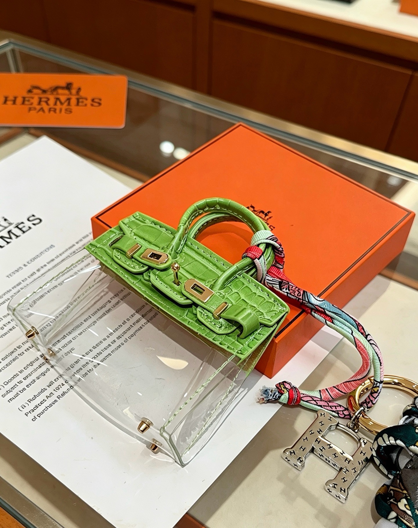 Hermes Birkin Bag Charm Keychain pendant Green crocodile-embossed leather gold-tone metal silver-tone metal multicolor printed silk dark green leather tassel clear vinyl 12cm total length