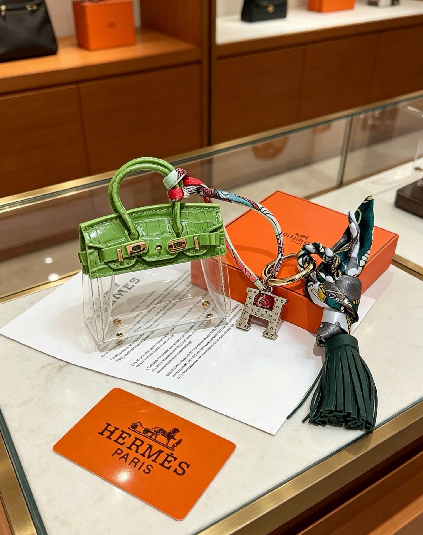 Hermes Birkin Bag Charm Keychain pendant Green crocodile-embossed leather gold-tone metal silver-tone metal multicolor printed silk dark green leather tassel clear vinyl 12cm total length