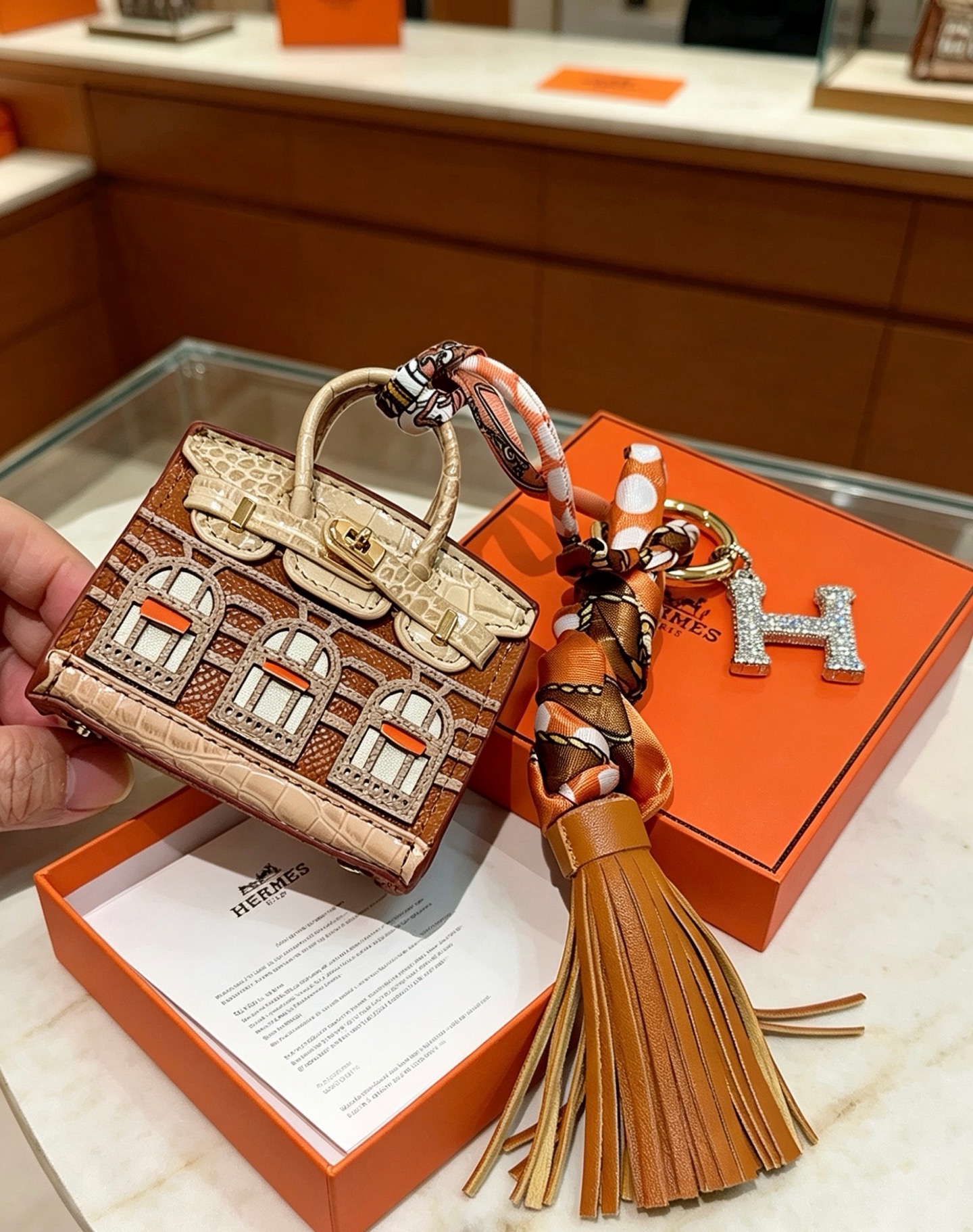 Hermes Birkin Faubourg Micro Bag Charm pendant Gold-tone metal brown beige orange leather orange brown beige silk clear crystal stones Total length 18cm