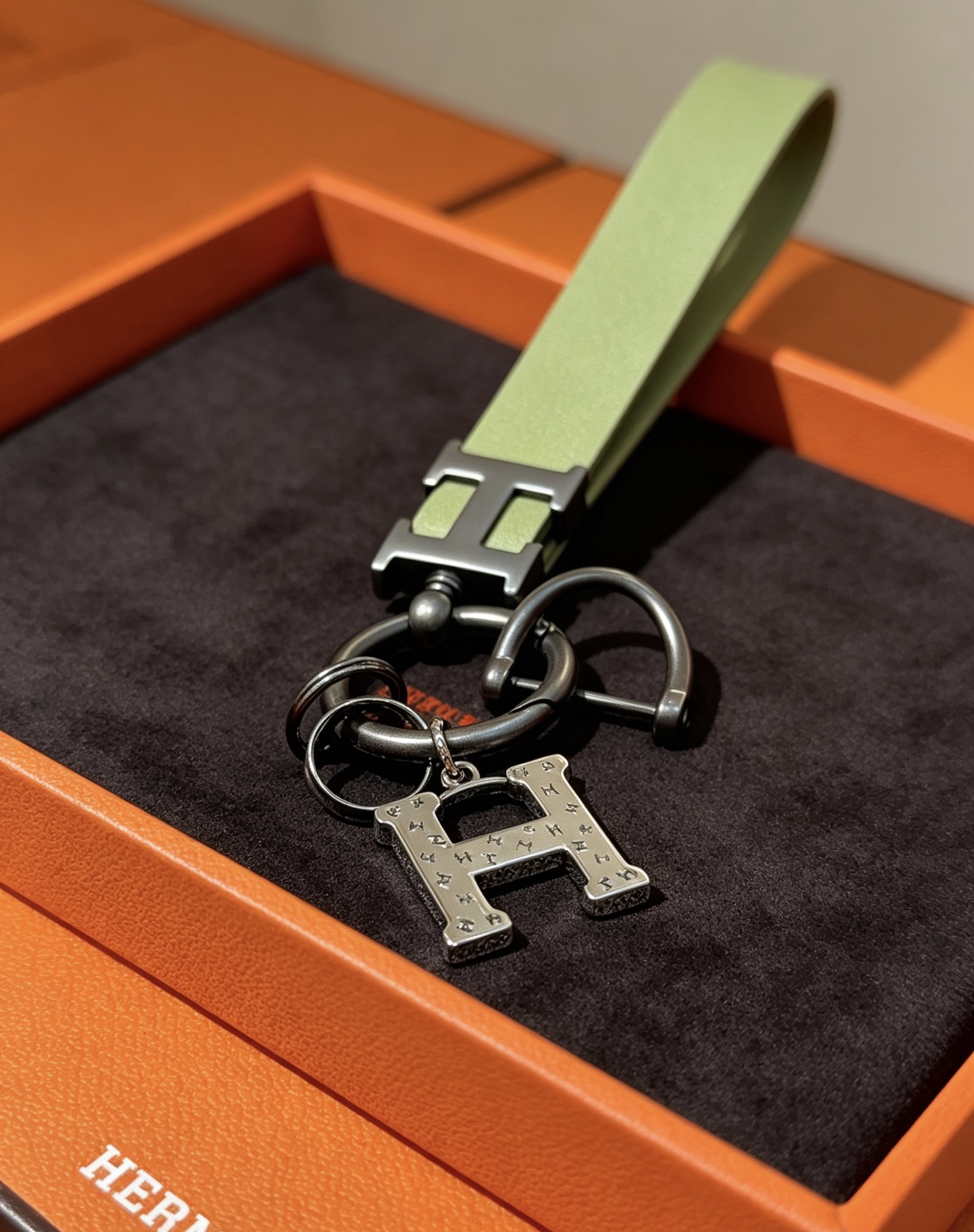 Hermes H Logo Leather Strap Keychain pendant Light green leather strap gunmetal gray metal hardware brushed silver H charm 12cm total length