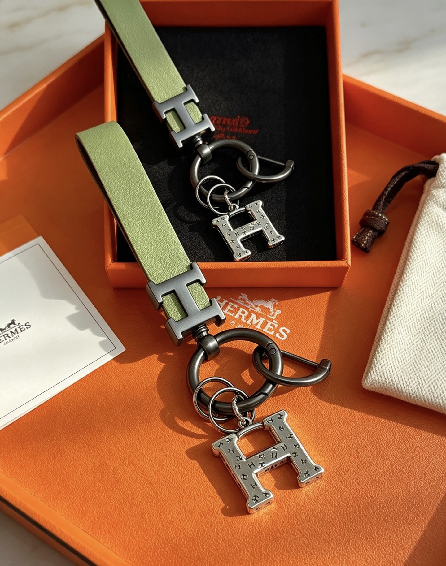 Hermes H Logo Leather Strap Keychain pendant Light green leather strap gunmetal gray metal hardware brushed silver H charm 12cm total length