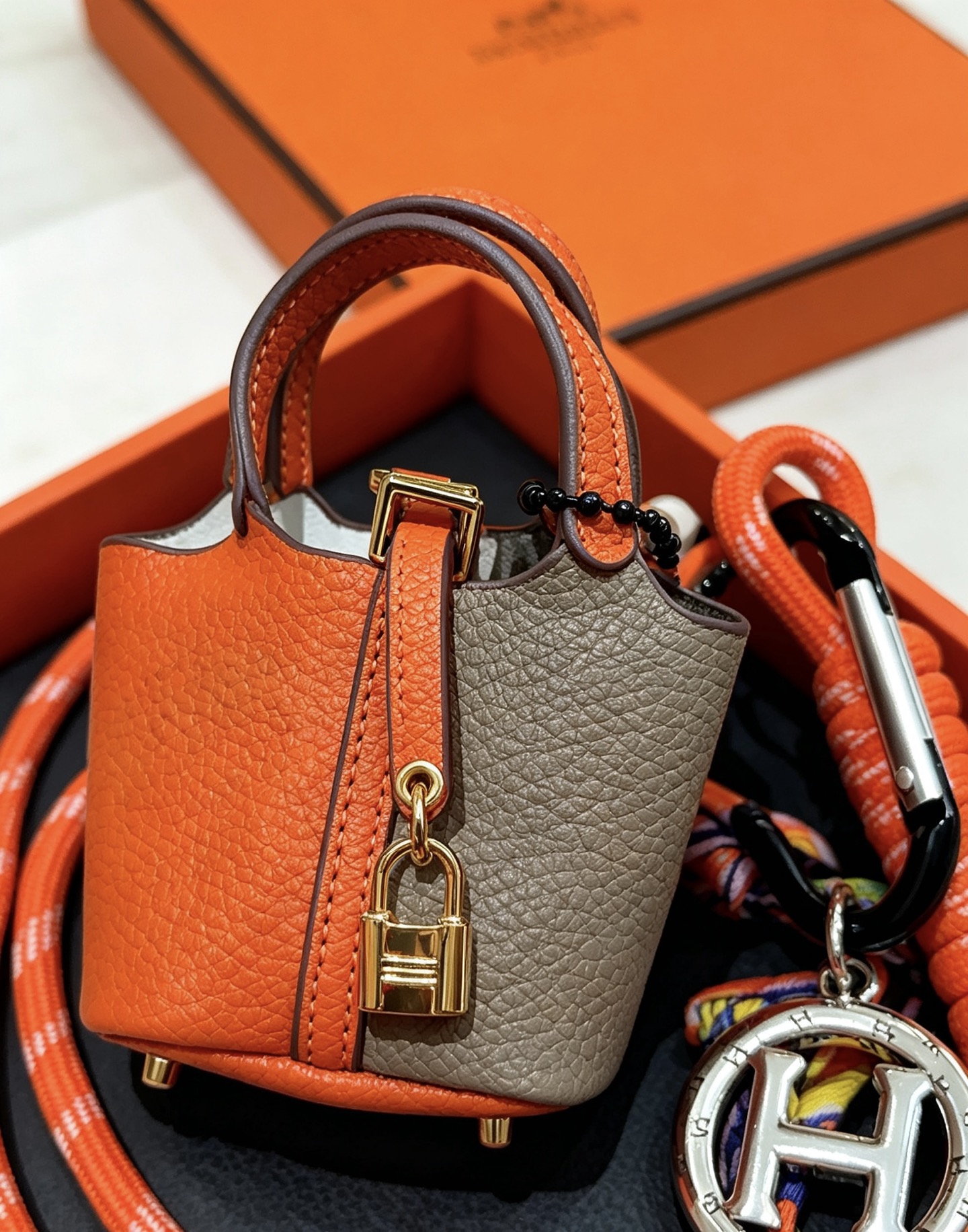 Hermes Mini Picotin Lock Bag Charm pendant Orange and gray leather gold-tone metal hardware silver-tone H logo charm multicolor silk cord accents 80cm