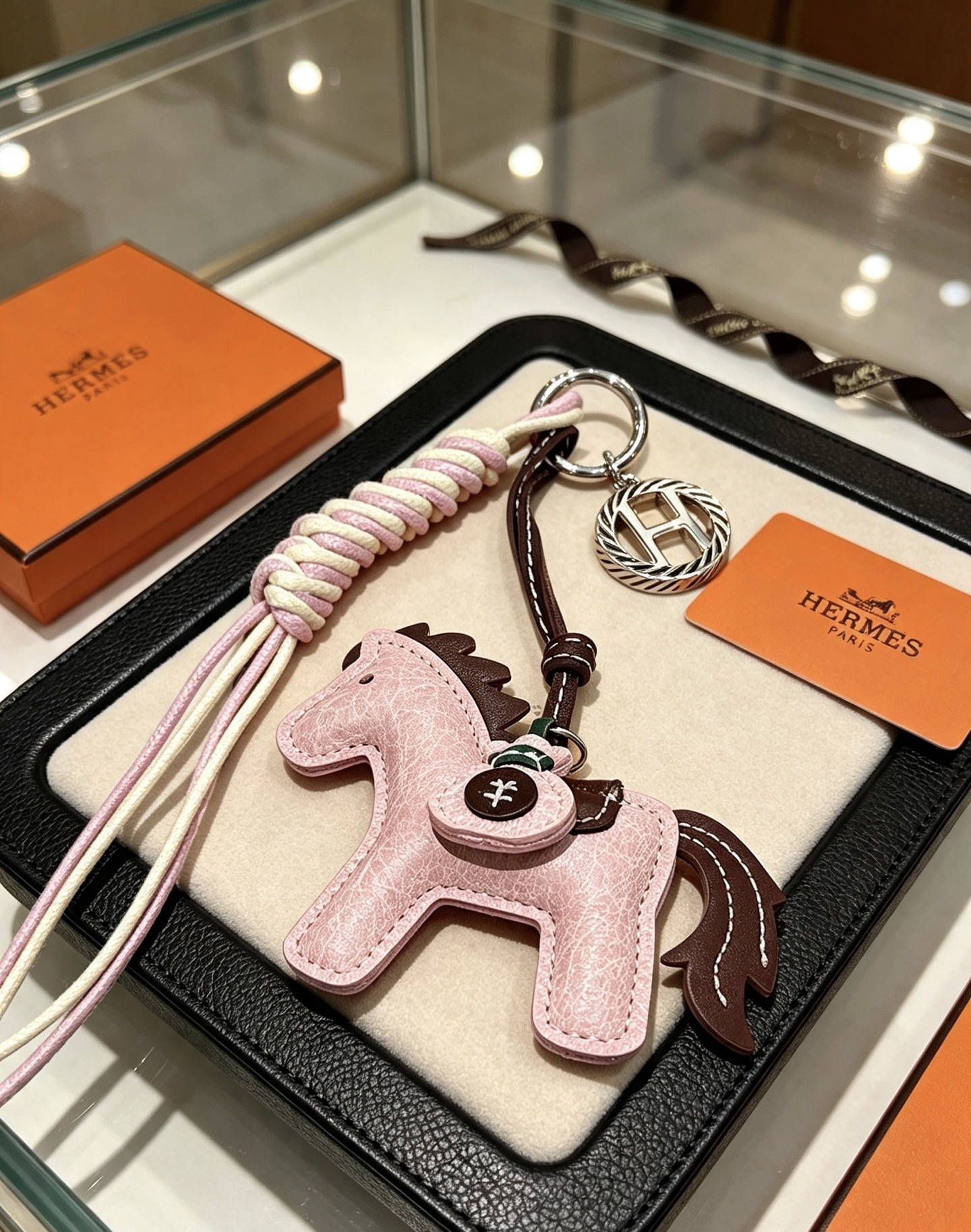 Hermes Rodeo Horse Key Charm pendant Light pink grained leather with dark brown leather accents cream and light pink braided cord silver-tone metal hardware 12cm total length