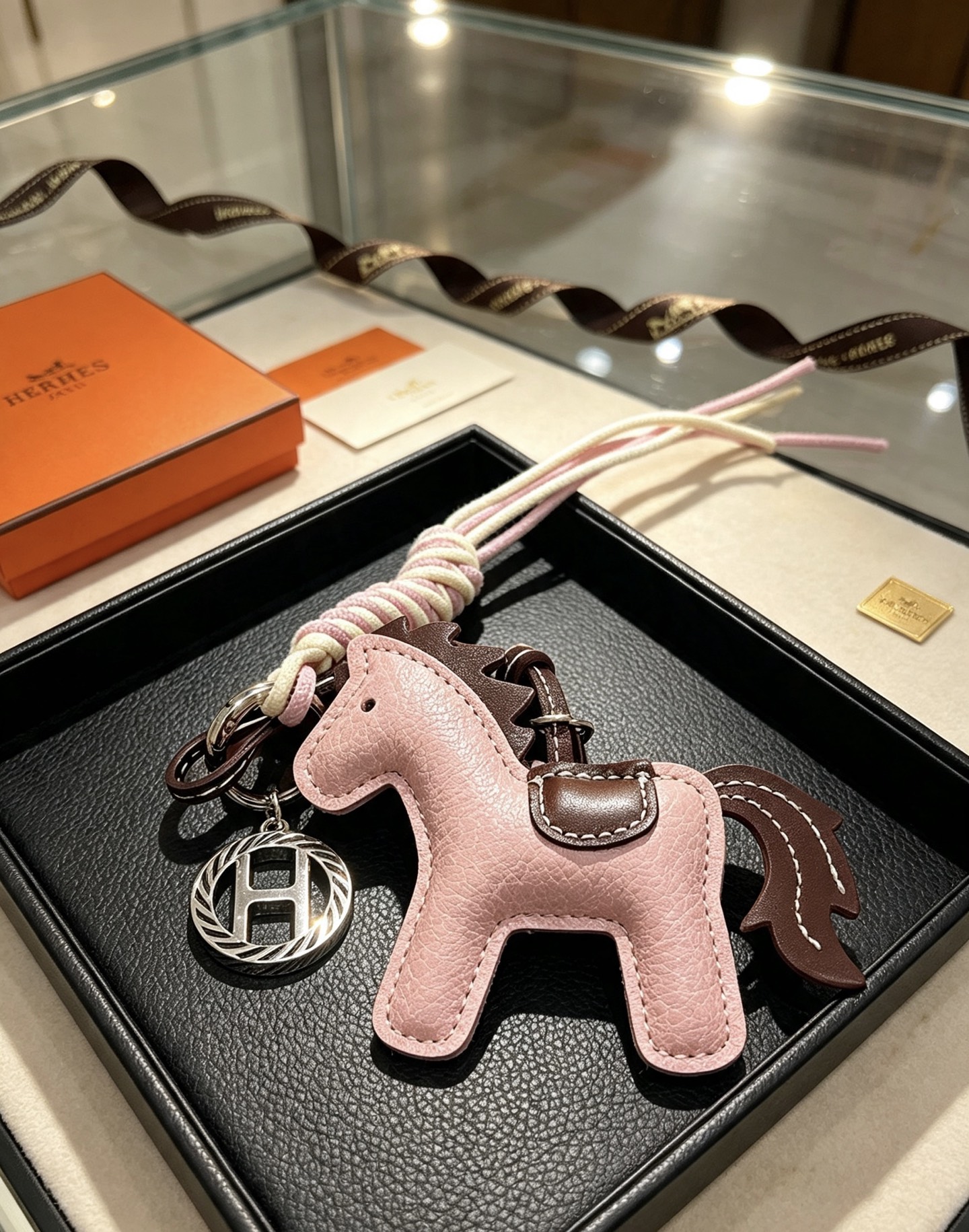 Hermes Rodeo Horse Key Charm pendant Light pink grained leather with dark brown leather accents cream and light pink braided cord silver-tone metal hardware 12cm total length