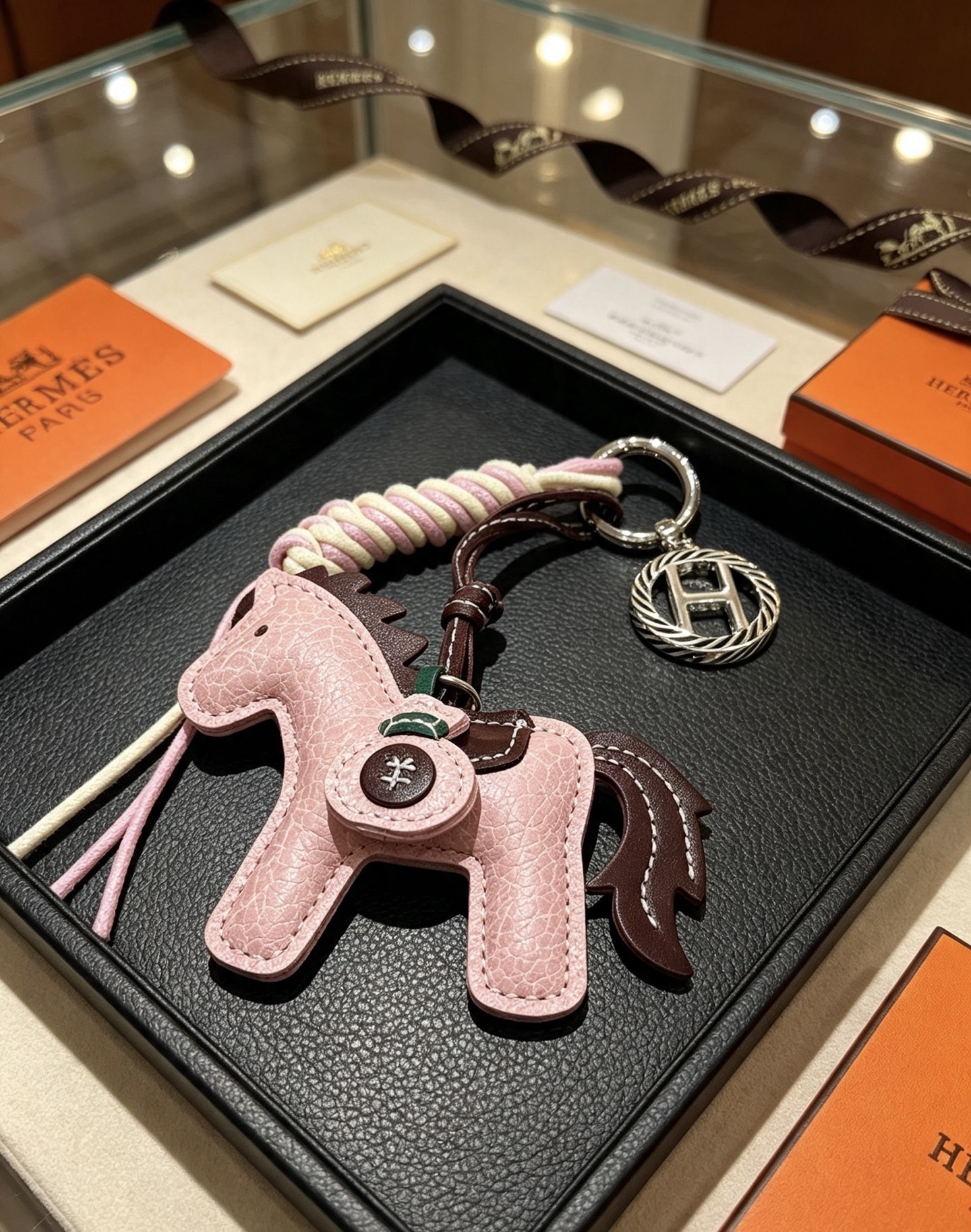 Hermes Rodeo Horse Key Charm pendant Light pink grained leather with dark brown leather accents cream and light pink braided cord silver-tone metal hardware 12cm total length
