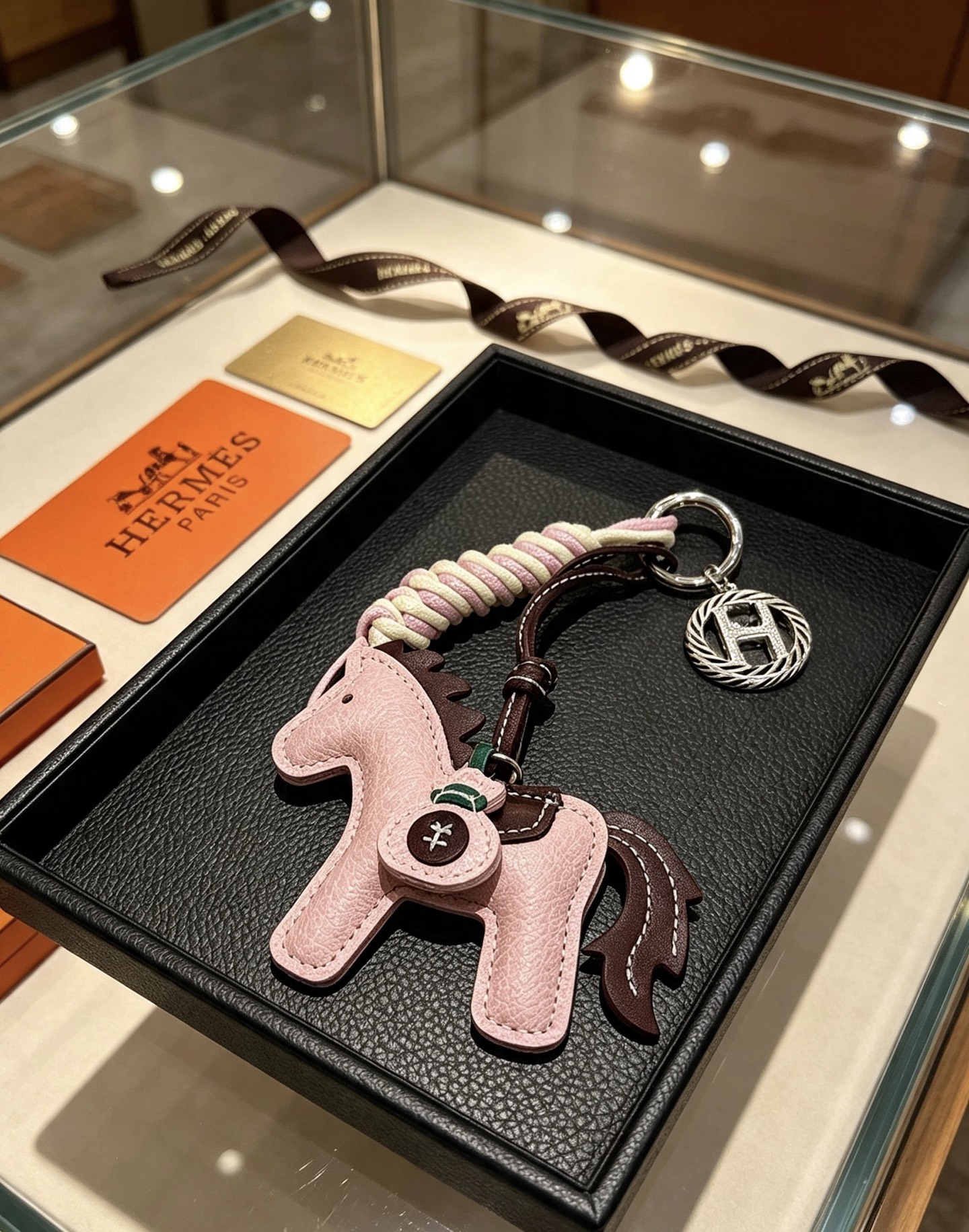Hermes Rodeo Horse Key Charm pendant Light pink grained leather with dark brown leather accents cream and light pink braided cord silver-tone metal hardware 12cm total length