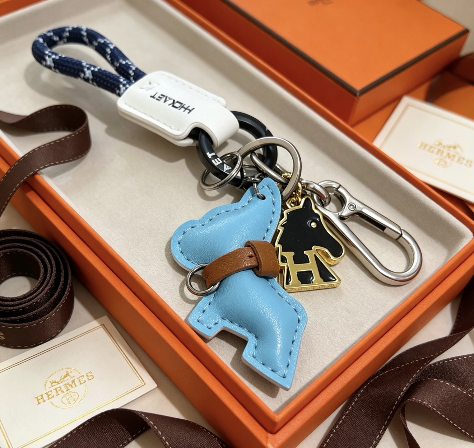 Hermes Cheval Horse Charm Keychain pendant Light blue leather brown leather white leather navy blue braided cord gunmetal hardware silver hardware gold-tone metal with black enamel 10cm total length