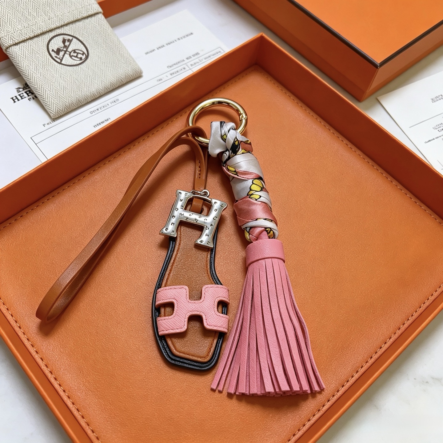 Hermes Oran Sandal Tassel Key Charm pendant Gold-tone metal silver-tone H hardware tan leather pink leather multicolor printed silk black edge trim 12cm total length