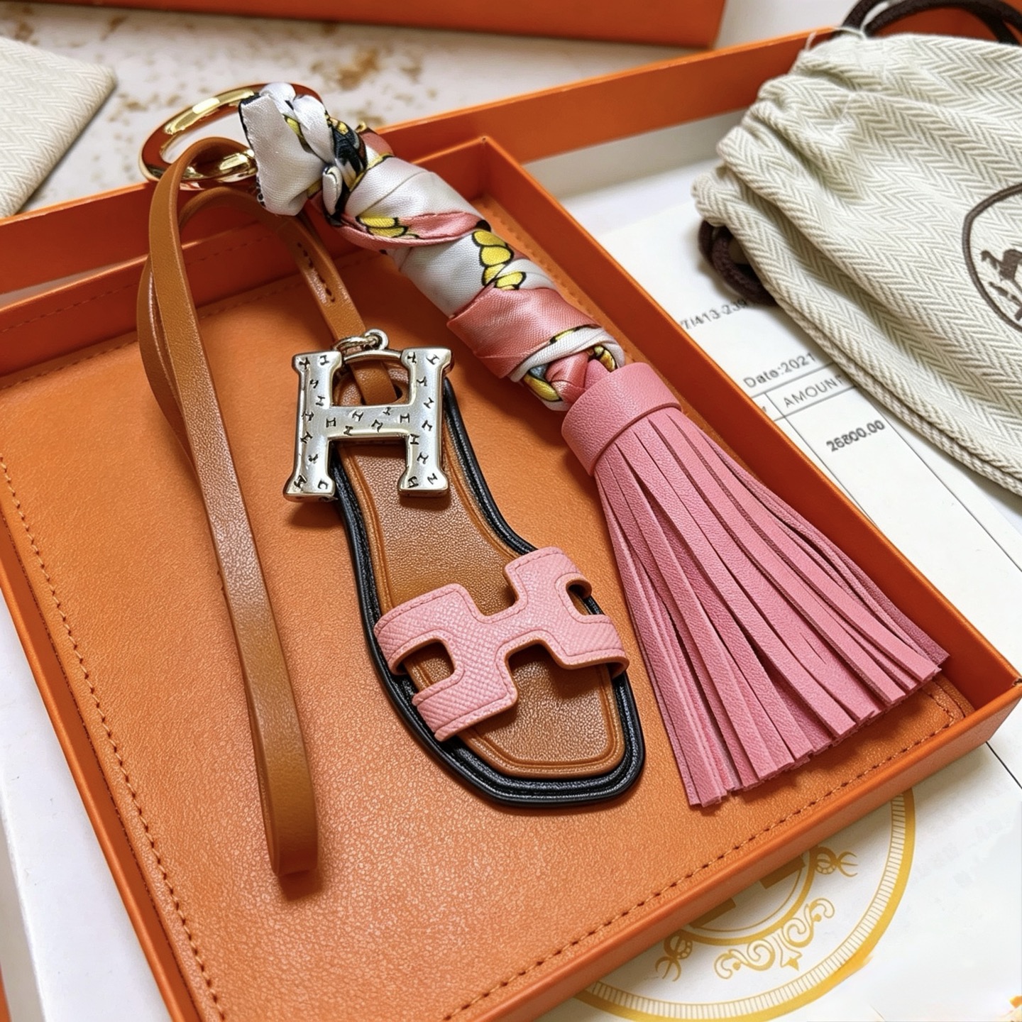 Hermes Oran Sandal Tassel Key Charm pendant Gold-tone metal silver-tone H hardware tan leather pink leather multicolor printed silk black edge trim 12cm total length
