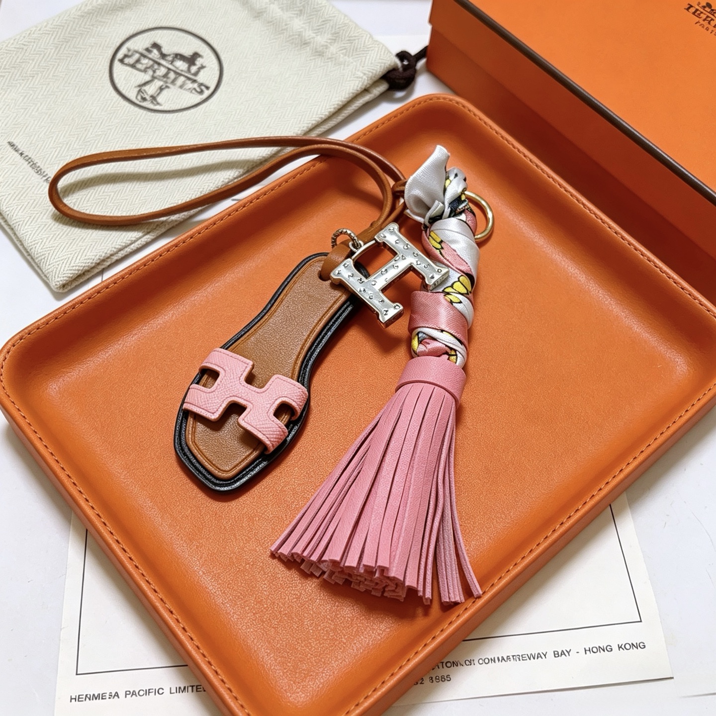 Hermes Oran Sandal Tassel Key Charm pendant Gold-tone metal silver-tone H hardware tan leather pink leather multicolor printed silk black edge trim 12cm total length
