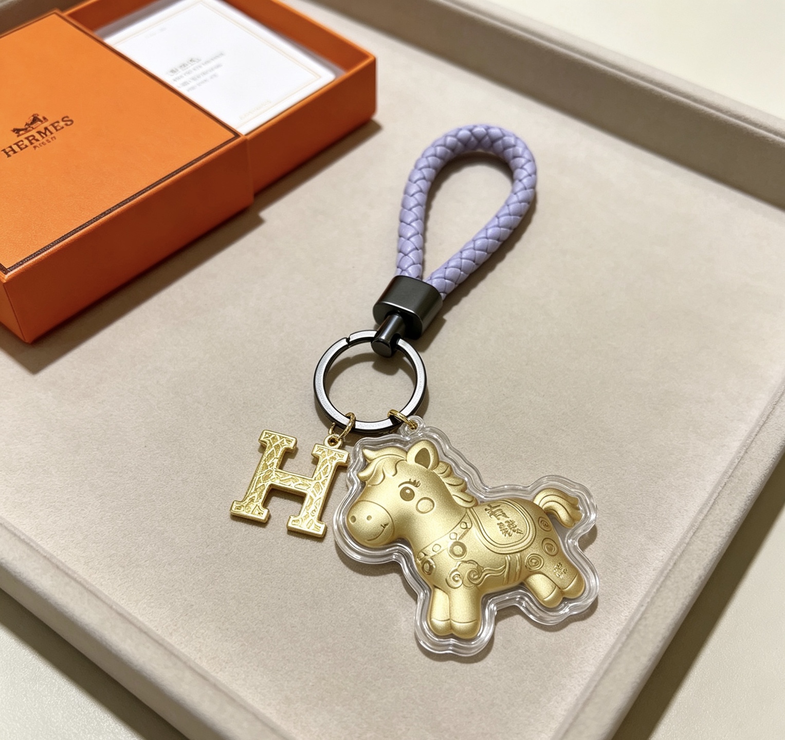 Hermes H Logo Lucky Horse Charm Keychain pendant matte gold metal lavender braided leather gunmetal hardware clear protective casing 12cm total length