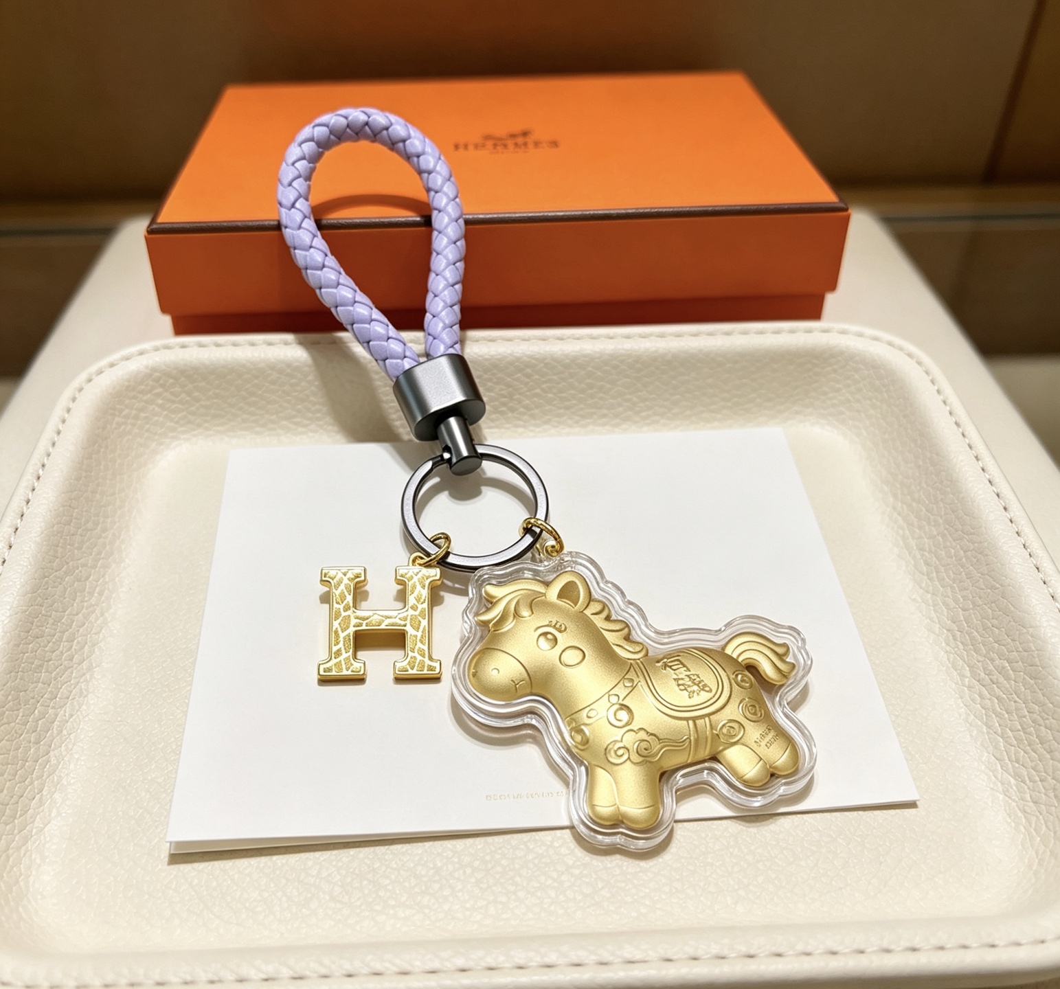 Hermes H Logo Lucky Horse Charm Keychain pendant matte gold metal lavender braided leather gunmetal hardware clear protective casing 12cm total length