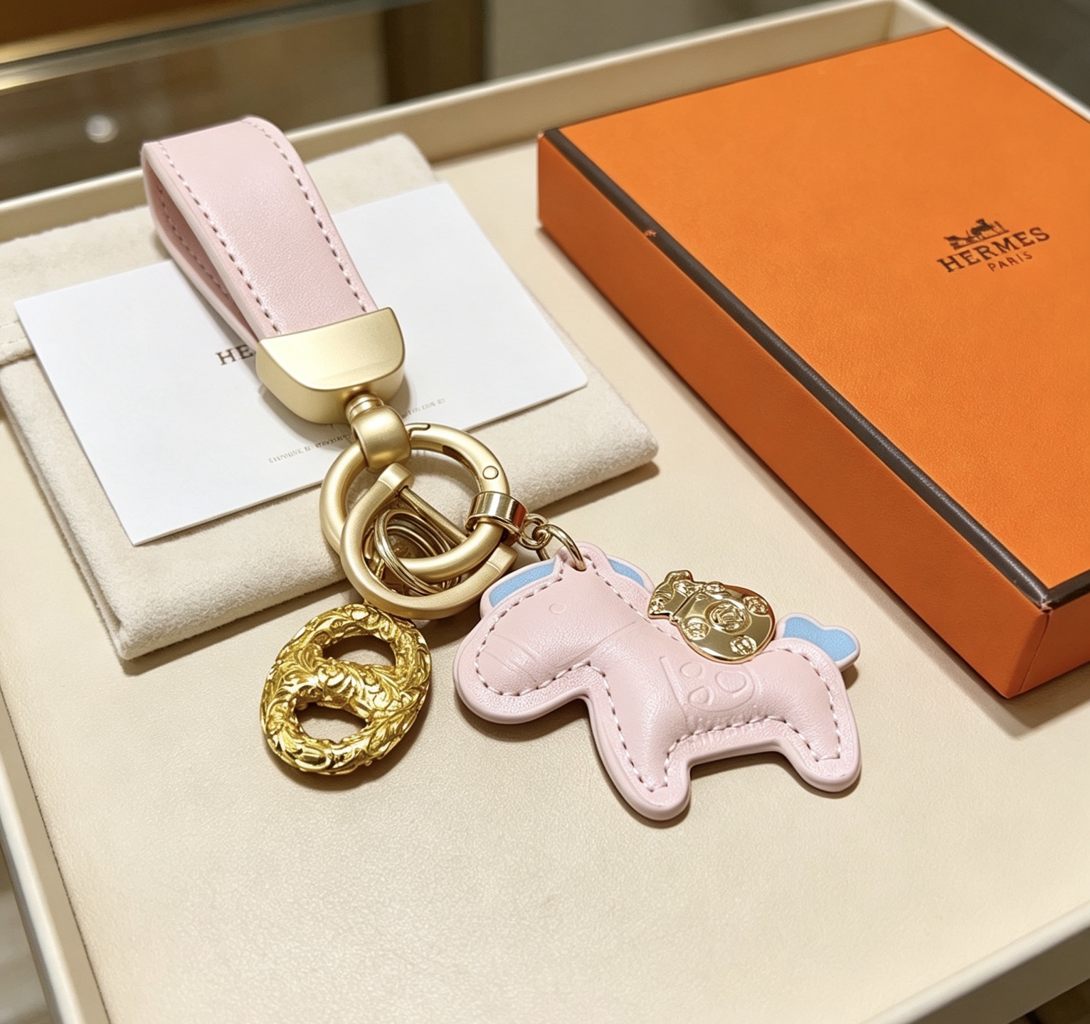 Hermes Rodeo Pony Key Charm pendant Light pink leather with light blue accents gold-tone metal hardware 12cm total length