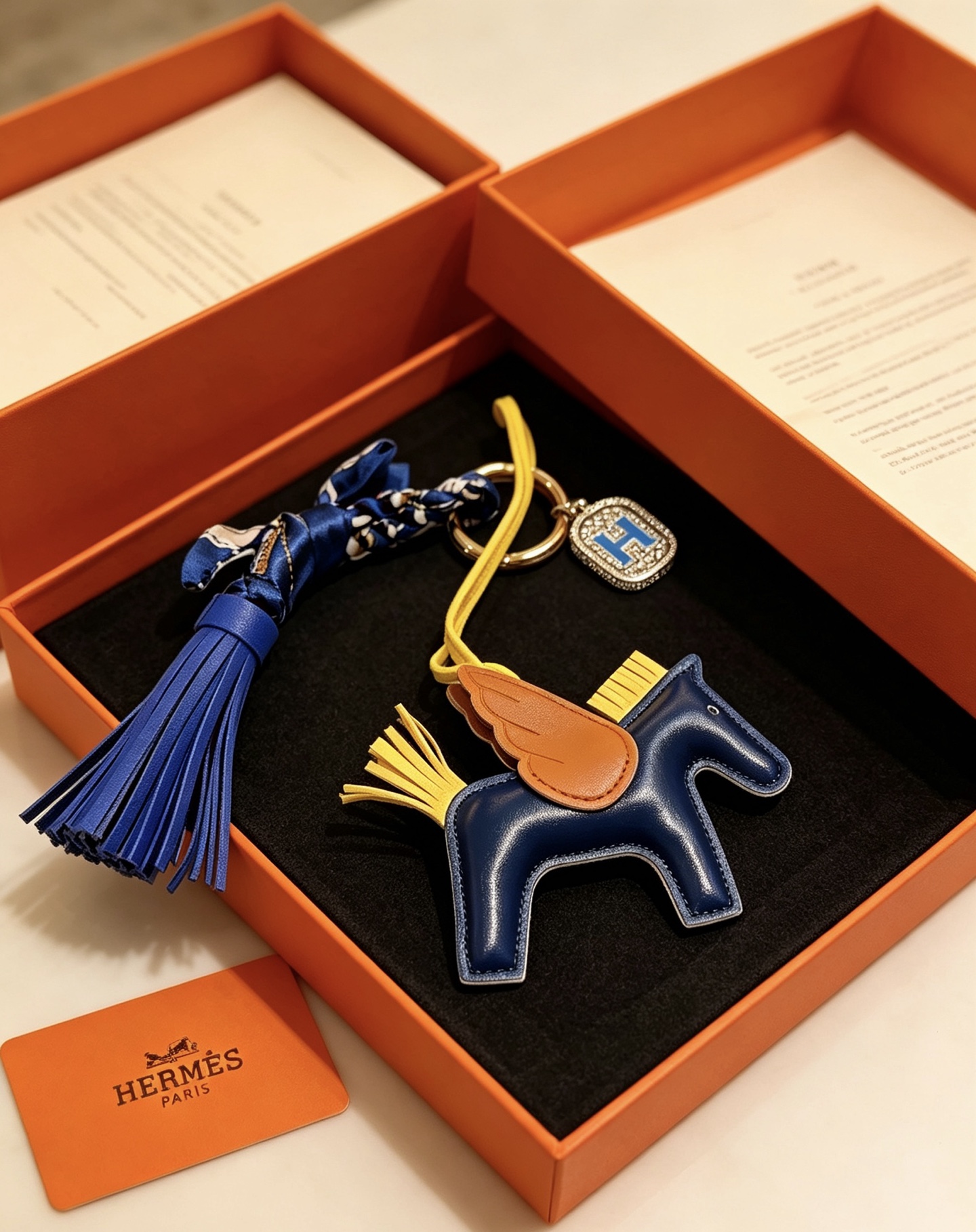 Hermes Rodeo Pegase H Logo Charm pendant Navy blue leather body tan leather wings yellow leather straps and mane bright blue leather tassels silver-tone metal with blue enamel H charm 10cm