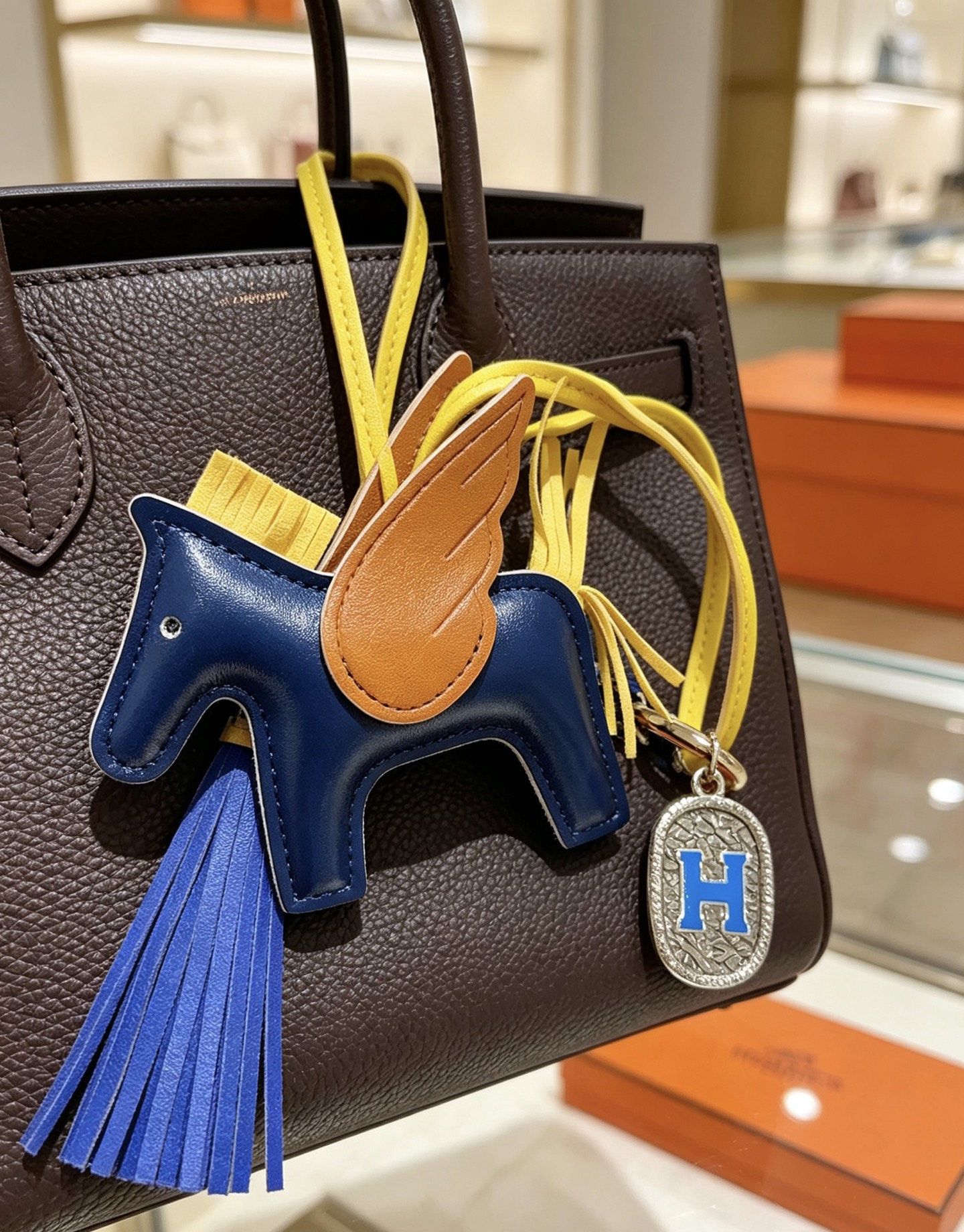 Hermes Rodeo Pegase H Logo Charm pendant Navy blue leather body tan leather wings yellow leather straps and mane bright blue leather tassels silver-tone metal with blue enamel H charm 10cm