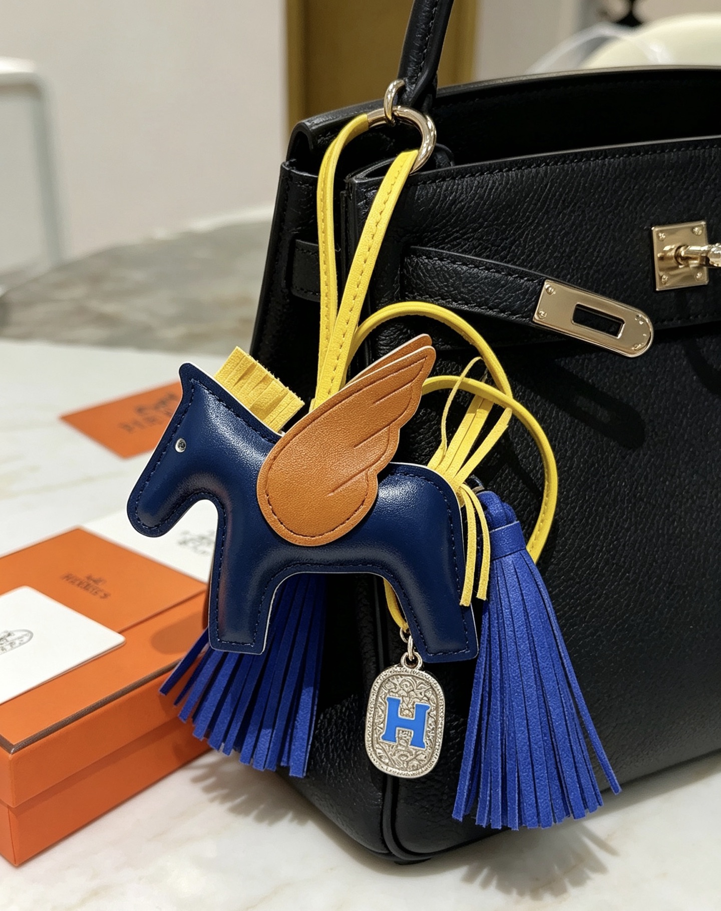 Hermes Rodeo Pegase H Logo Charm pendant Navy blue leather body tan leather wings yellow leather straps and mane bright blue leather tassels silver-tone metal with blue enamel H charm 10cm