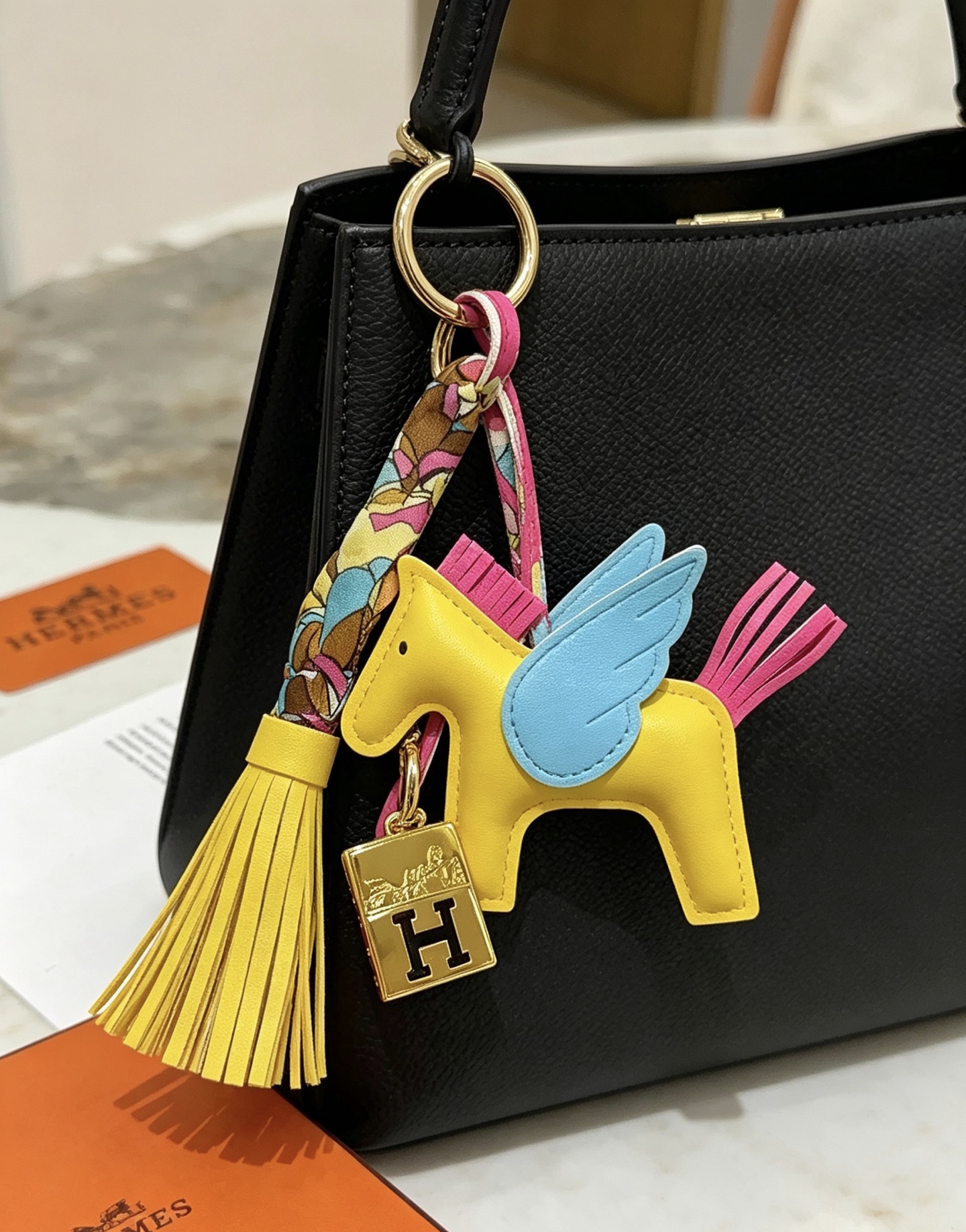 Hermes Rodeo Pegase Charm pendant Yellow lambskin with light blue wings fuchsia mane tail gold-tone H logo hardware multicolor silk twilly accent yellow leather tassel 8cm