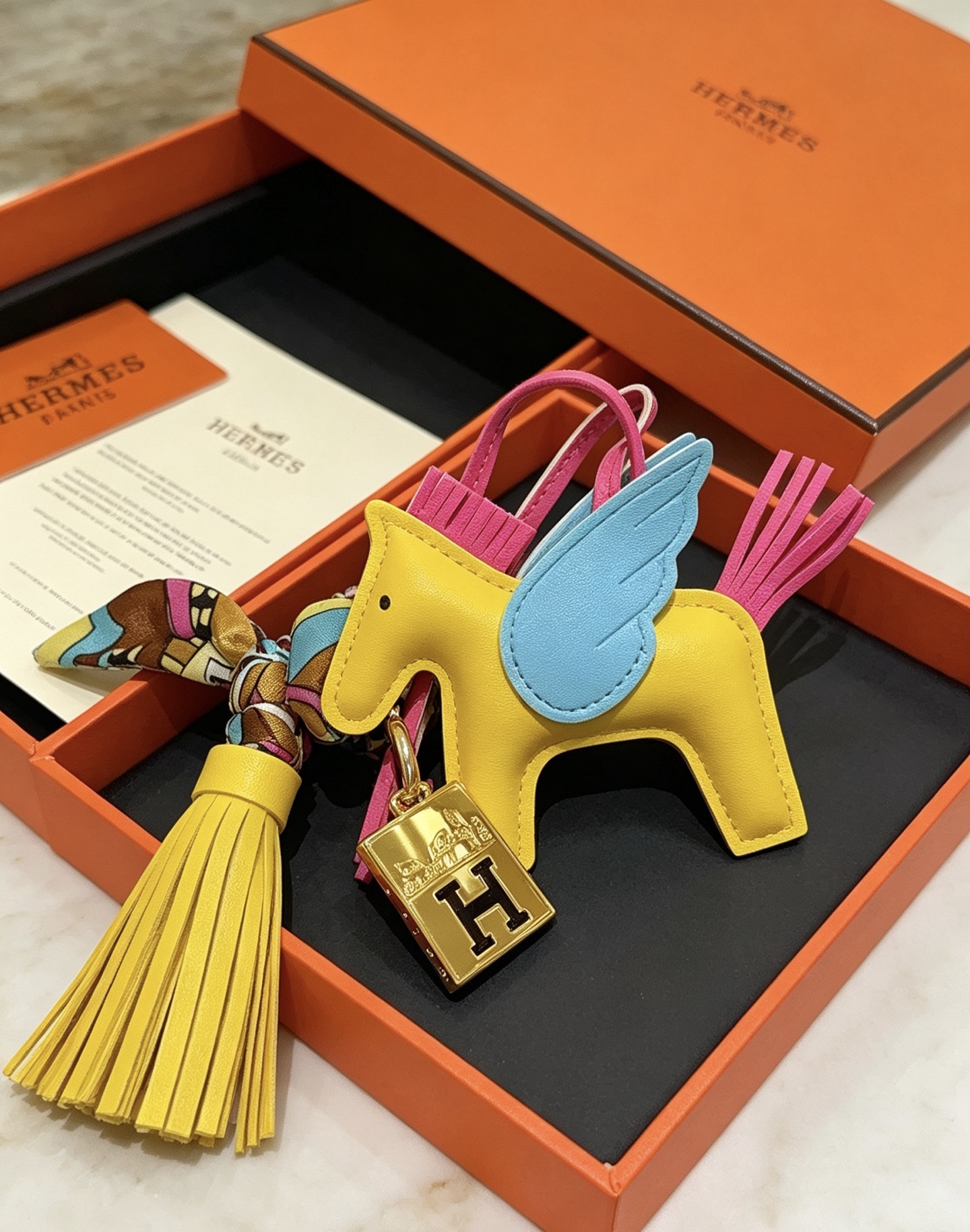 Hermes Rodeo Pegase Charm pendant Yellow lambskin with light blue wings fuchsia mane tail gold-tone H logo hardware multicolor silk twilly accent yellow leather tassel 8cm