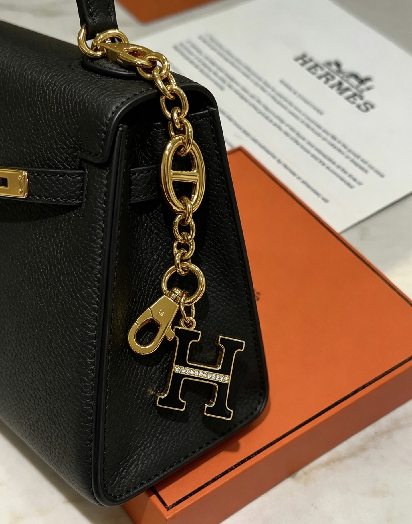Hermes H Logo Chaine d Ancre Bag Charm Keychain pendant Gold-tone metal with black enamel and clear crystal accents 16cm