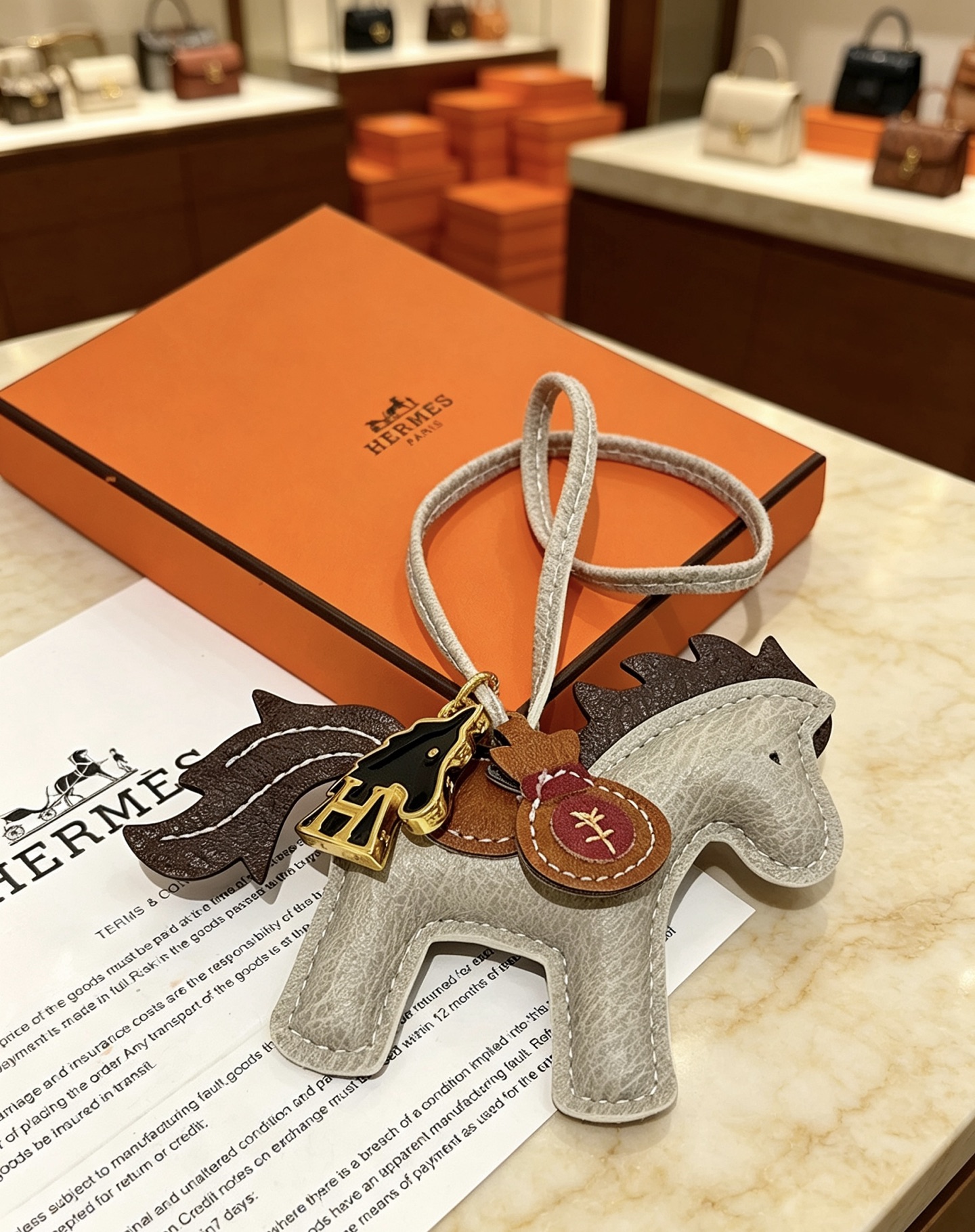 Hermes Rodeo Pegase Horse Bag Charm pendant Light gray grained leather with dark brown leather mane tail tan leather saddle gold-tone metal hardware black enamel H horse charm burgundy leather money bag charm 8cm charm with 12cm leather strap