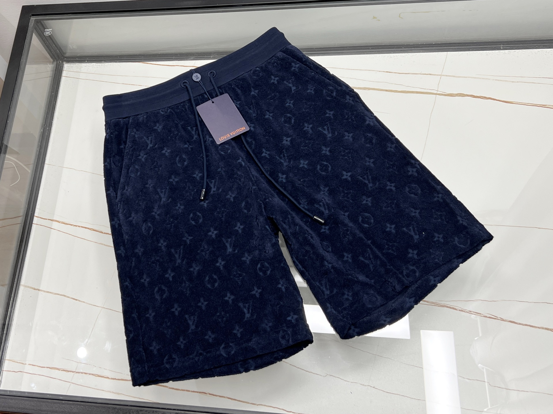 NO:720975,-26SS——The dark pattern fashion shorts are a low-key and luxurious summer choice. The dark pattern fashion shorts are a low-key and eye-catching presence in the summer wardrobe. They abandon the big and flamboyant patterns and outline the unique charm with delicate dark patterns, inadvertently showing the wearer's extraordinary taste.  Its shape is neat, slim but not tight, and can perfectly outline the lines of the legs, making them appear longer and straighter. The fabric is skin-friendly and breathable, keeping you fresh and comfortable even in the hot summer. In terms of matching, it is extremely versatile, and paired with a simple white T, it looks youthful and energetic; paired with a shirt, it adds a bit of formality, making it easy to control whether it is a casual outing or daily commuting, helping you to easily create your own fashion style.  Available now in 2 colors S-XL, Louis Vuitton-clothing, louis vuitton, shorts, shirts,19860909-26SS——暗纹时尚短裤低调奢华的夏日之选 暗纹时尚短裤,是夏日衣橱里低调又吸睛的存在.它摒弃了张扬的大图案,以细腻暗纹勾勒独特韵味,在不经意间展现穿着者的不凡品味. 其版型利落,修身而不紧绷,能完美勾勒腿部线条,让双腿更显修长笔直.面料亲肤透气,即便在炎炎夏日,也能保持清爽舒适.搭配上,它极为百搭,与简约白 T 搭配,青春活力；配上一件衬衫,又多了几分正式感,无论是休闲出游还是日常通勤,都能轻松驾驭,助你轻松打造出属于自己的时尚风格. 现货发售2色S-XL,路易威登-服装,louis vuitton,shorts,shirts,,Women's clothing