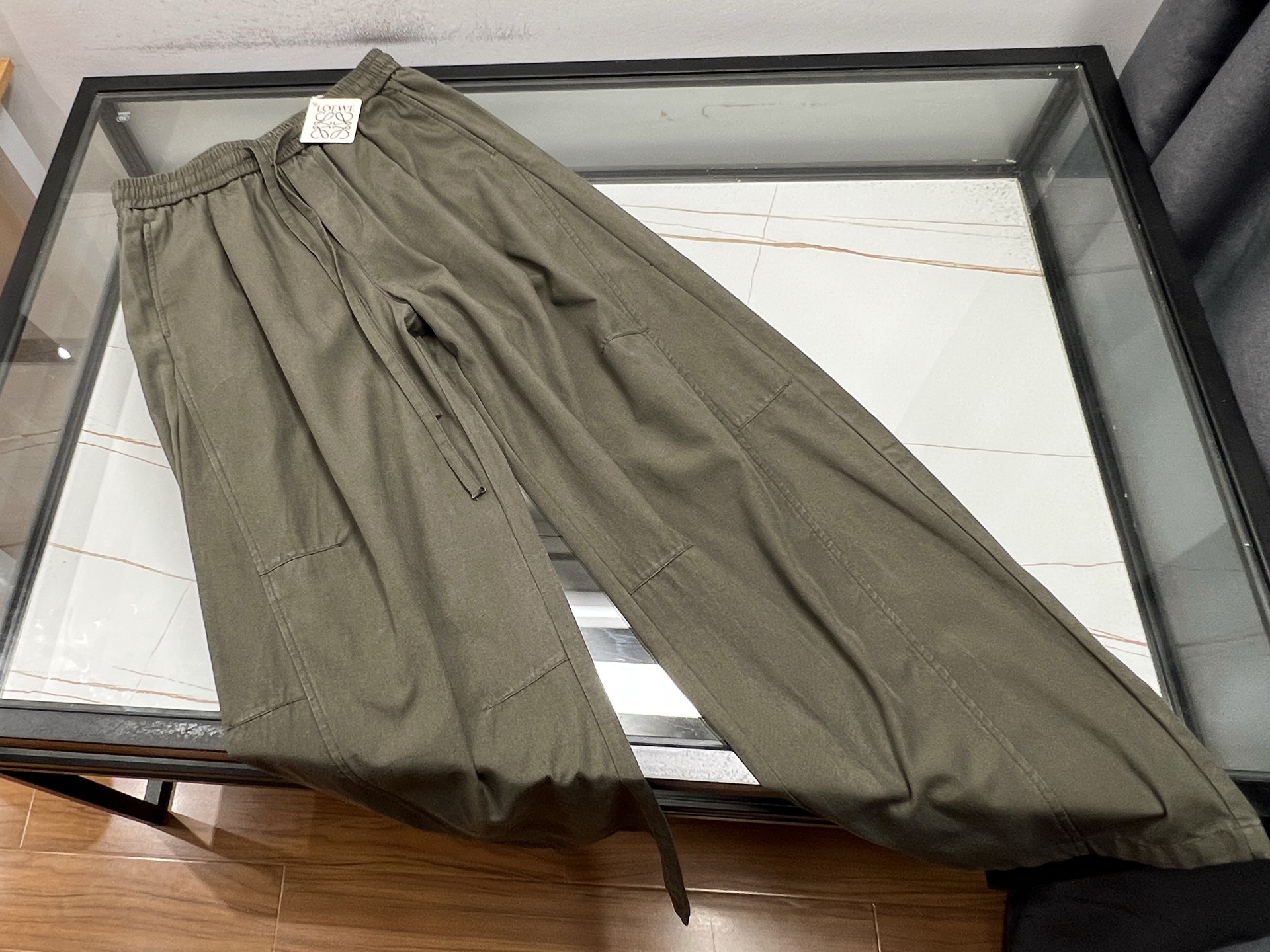 NO:777517,-26SS——Wide-leg casual fashion pants are a must-have item in the wardrobe of today's fashionistas. They are designed with loose trouser legs and cleverly modify the shape of the legs. They can be easily controlled regardless of thickness, showing a casual and comfortable fashion attitude. The fabrics are mostly made of soft and comfortable cotton or highly drapey chiffon, which provides an excellent wearing experience, breathability and skin-friendly.  It can be combined with a simple T-shirt to create an everyday casual style; or paired with a slim-fitting sweater to highlight your elegance; and paired with a pair of white shoes or loafers, you can easily walk around the city streets. Whether commuting or weekend gatherings, wide-leg casual fashion pants can make you the center of attention, showing your unique charm and fashionable taste.  Ready for sale green XS-S-M-L, Loewe-clothing, loewe, loafers, tees, t-shirt,19860909-26SS———阔腿休闲时尚裤,是当下潮流达人的衣橱必备单品.它以宽松的裤腿设计,巧妙修饰腿型,无论粗细皆能轻松驾驭,展现出随性自在的时尚态度.面料上多选用柔软舒适的棉质或垂坠感强的雪纺,穿着体验极佳,透气又亲肤.搭配上更是百变多样,可与简约T恤组合,打造日常休闲风；或配以修身针织衫,凸显优雅气质；再搭上一双小白鞋或乐福鞋,轻松游走于都市街头.无论是通勤出行还是周末聚会,阔腿休闲时尚裤都能让你成为焦点,尽显独特魅力与时尚品味. 现货发售绿色XS-S-M-L,罗意威-服装,loewe,loafers,tees，t-shirt,,Women's clothing