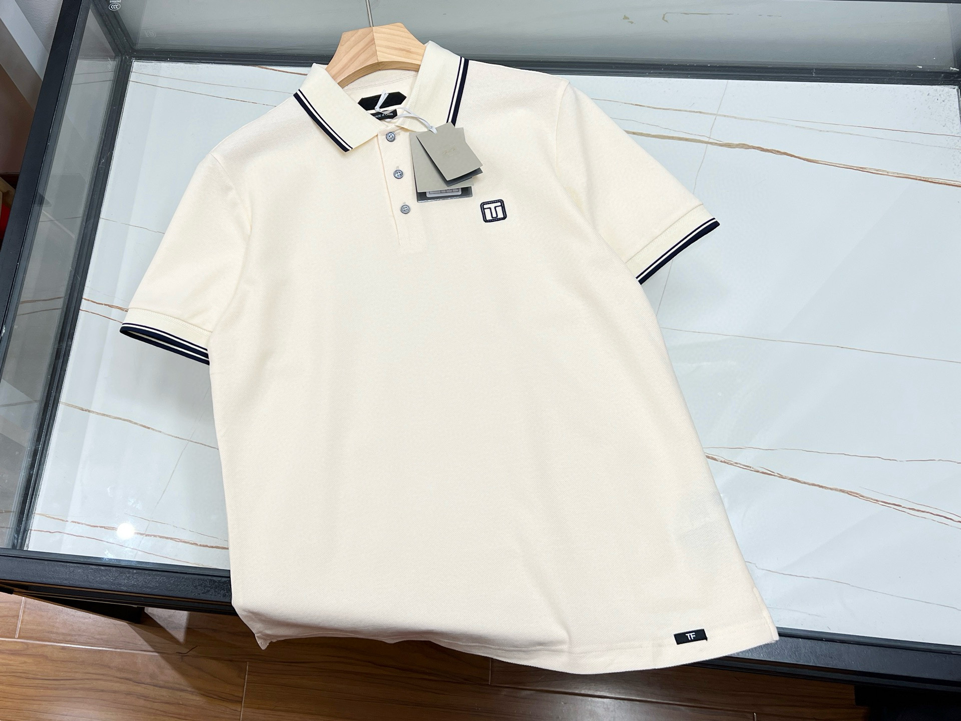 NO:783250,——TF simple letter short sleeves, with its streamlined yet fashionable design concept, have become a must-have item in the summer wardrobe. This short sleeve is made of high-quality fabrics, soft and comfortable to the touch, and has good breathability, which can keep the skin dry and comfortable even in the hot summer. The highlight of its design is the simple and generous letter logo on the chest, which reveals the unique charm of the brand in a low-key manner. Whether worn alone or as an inner layer, it can easily control a variety of styles.  In terms of style, the TF simple lettered short-sleeves are well-cut, not restricting the body but also able to modify the figure well, and are suitable for people of all shapes and sizes. In terms of color, a variety of basic colors are provided for consumers to choose from, whether it is the classic and versatile black, white and gray, or the fresh and bright macaron color series, which can meet the matching needs of different occasions and moods.  In short, with its high-quality fabrics, simple yet stylish design, and various color choices, TF simple letter short-sleeves have become the first choice for consumers who pursue both fashion and comfort. Whether it is daily travel or casual gatherings, it can make you the focus and show your personal charm. Available in stock, navy/black 48-50-52-54; off-white/white 48-50-52-54-56, men's clothing, tom ford, T-shirt,19860909———TF简约字母短袖,以其精简而不失时尚的设计理念,成为夏日衣橱中的必备单品.这款短袖采用优质面料,触感柔软舒适,透气性好,即便是炎炎夏日也能保持肌肤的干爽与自在.其设计亮点在于胸前简洁大方的字母标识,低调中透露出品牌的独特韵味,无论是单穿还是作为内搭,都能轻松驾驭多种风格. 版型上,TF简约字母短袖剪裁得体,既不束缚身体又能很好地修饰身形,适合各种身材的人群穿着.颜色方面,提供多种基础色调供消费者选择,无论是经典百搭的黑白灰,还是清新明亮的马卡龙色系,都能满足不同场合与心情的搭配需求. 总之,TF简约字母短袖以其高品质的面料、简约而不失格调的设计,以及多样的色彩选择,成为了追求时尚与舒适并重的消费者的优选.无论是日常出行还是休闲聚会,它都能让你成为焦点,展现个人魅力. 现货发售藏青/黑色48-50-52-54；米白/白色48-50-52-54-56,男装,tom ford,T-shirt,,Women's clothing