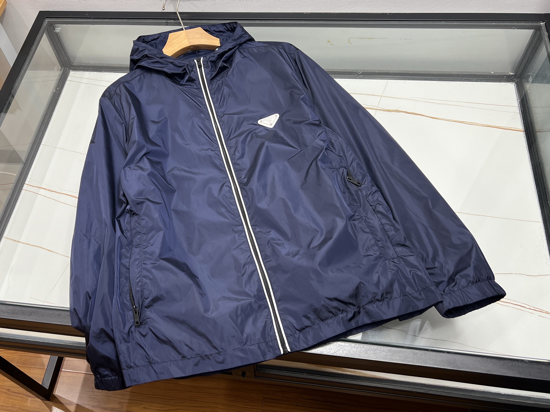 NO:943099,-26SS——Letter zipper autumn and winter casual windbreaker jacket  This autumn and winter casual windbreaker combines fashionable texture and practicality. It is made of thick windproof woven fabric to resist the cold autumn wind, and the upper body is stiff and not easy to wrinkle. The neat stand-up collar is matched with the metal letter zipper that runs through the body, making it highly recognizable. The simple design has a high-end street atmosphere. The loose shoulder cut is adaptable to various body shapes, and there is no restriction in movement. It is suitable for daily layered sweaters. Side  The hidden pockets are both beautiful and practical, and the lines are neat and delicate. The length of the jacket is just right, modifying the body proportions without weighing down your figure. The solid color base is low-key and versatile, and can be paired with jeans or casual trousers. It is suitable for commuting, traveling, and daily shopping. With both warmth and trendy design, one piece can easily support the entire autumn and winter outfits. It is simple and not monotonous. It is a versatile jacket that boys need in autumn and winter.  Available now in two colors M-XXXL, Prada-clothing, prada, hoodie, sweatshirts, jeans, jackets & coats, sweaters,19860909-26SS——字母拉链秋冬休闲风衣外套 这款秋冬休闲风衣兼顾时尚质感与实穿性,甄选厚实防风梭织面料,抵御秋风寒气,上身挺括不易起皱.利落立领搭配贯穿衣身的金属字母拉链,辨识度拉满,简约设计自带高级街头氛围.宽松落肩剪裁包容各种身形,活动无束缚,日常叠穿毛衣卫衣都适配.侧边隐形口袋兼顾美观与实用性,走线工整细腻.衣长恰到好处,修饰身材比例,不压个子.纯色基底低调百搭,搭配牛仔裤、休闲西裤均可,通勤、出游、日常逛街都合适.兼具保暖度与潮流设计,一件轻松撑起整个秋冬穿搭,简约不单调,是男生秋冬百搭刚需外套. 现货发售二色M-XXXL,普拉达-服装,prada,hoodie,sweatshirts,jeans,jackets & coats,sweaters,,Women's clothing
