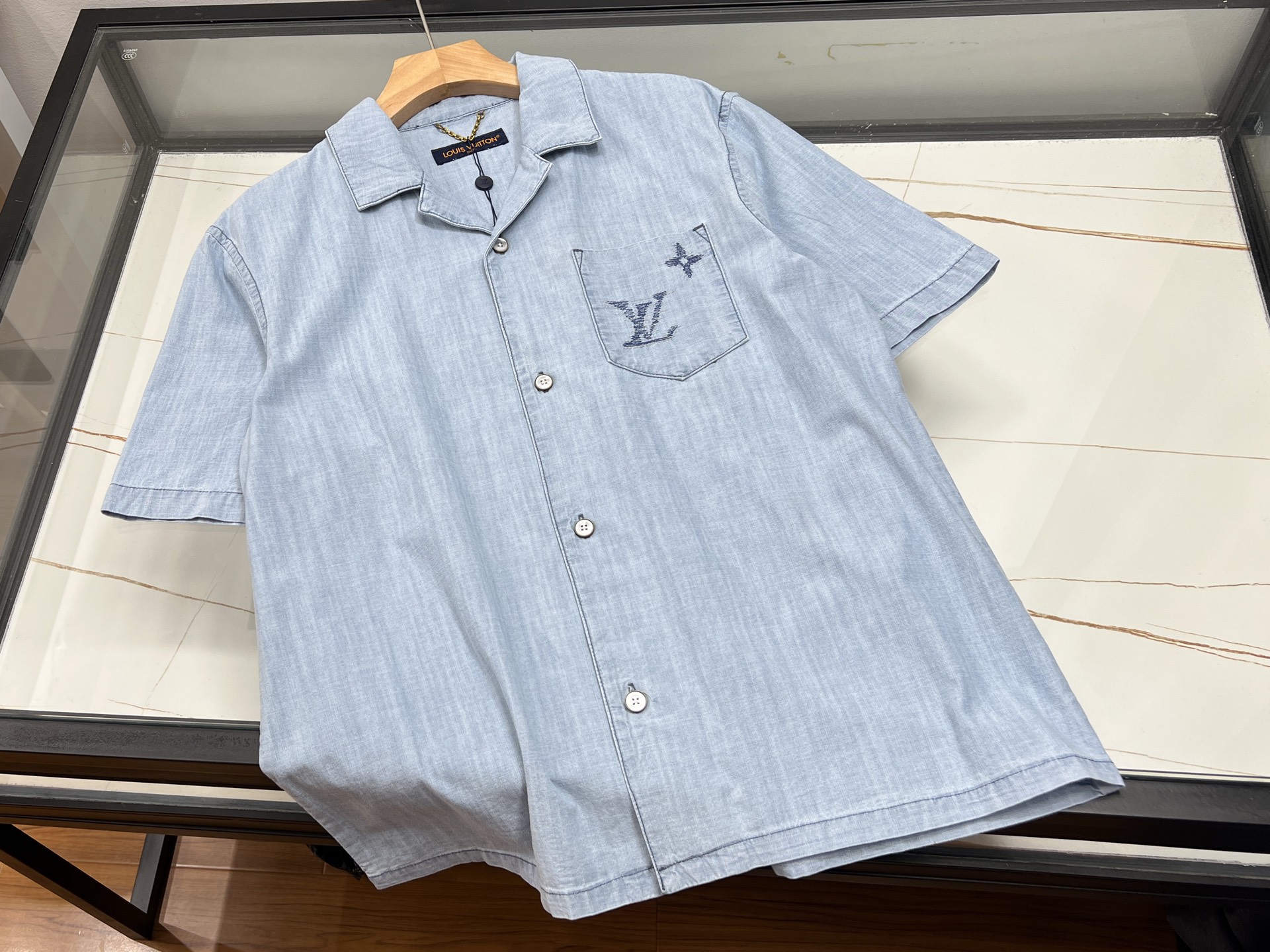 NO:948119,-26SS——V embroidered letter lapel short sleeves, creating a refreshing and refined men's look. Retro Cuban lapel design, simple and neat lines, with a relaxed atmosphere. The loose straight version accommodates all body shapes, allowing unrestricted movement. The chest pocket is embellished with exquisite embroidered letter logos, with exquisite craftsmanship and low-key style. Selected soft and breathable surface  The material is smooth to the touch, refreshing and not sweaty when worn. The single-row metal buttons are simple and elegant, with exquisite details. The solid color background is versatile and durable, suitable for daily commuting and holiday travel. It can be paired with casual trousers and denim trousers to easily create a variety of dressing styles. The solid seaming technology is durable and not easy to deform, making it an indispensable basic item for the spring and summer wardrobe.  Ready for sale blue S-XL, Louis Vuitton-clothing, louis vuitton, T-shirt,19860909-26SS——V刺绣字母翻领短袖,塑造清爽精致男士造型.复古古巴翻领设计,线条简约利落,自带松弛氛围感.宽松直筒版型包容各类身形,活动无拘束.胸前口袋点缀精致刺绣字母标识,工艺细腻,低调凸显格调.甄选柔软透气面料,触感顺滑,穿着清爽不闷汗.单排金属纽扣简约大气,细节考究.纯色底色百搭耐看,日常通勤、假日出行都适配.可搭配休闲西裤、牛仔长裤,轻松打造多种穿搭风格.扎实锁边工艺,耐穿不易变形,是春夏衣橱不可或缺的基础单品. 现货发售蓝色S-XL,路易威登-服装,louis vuitton,T-shirt,,Women's clothing