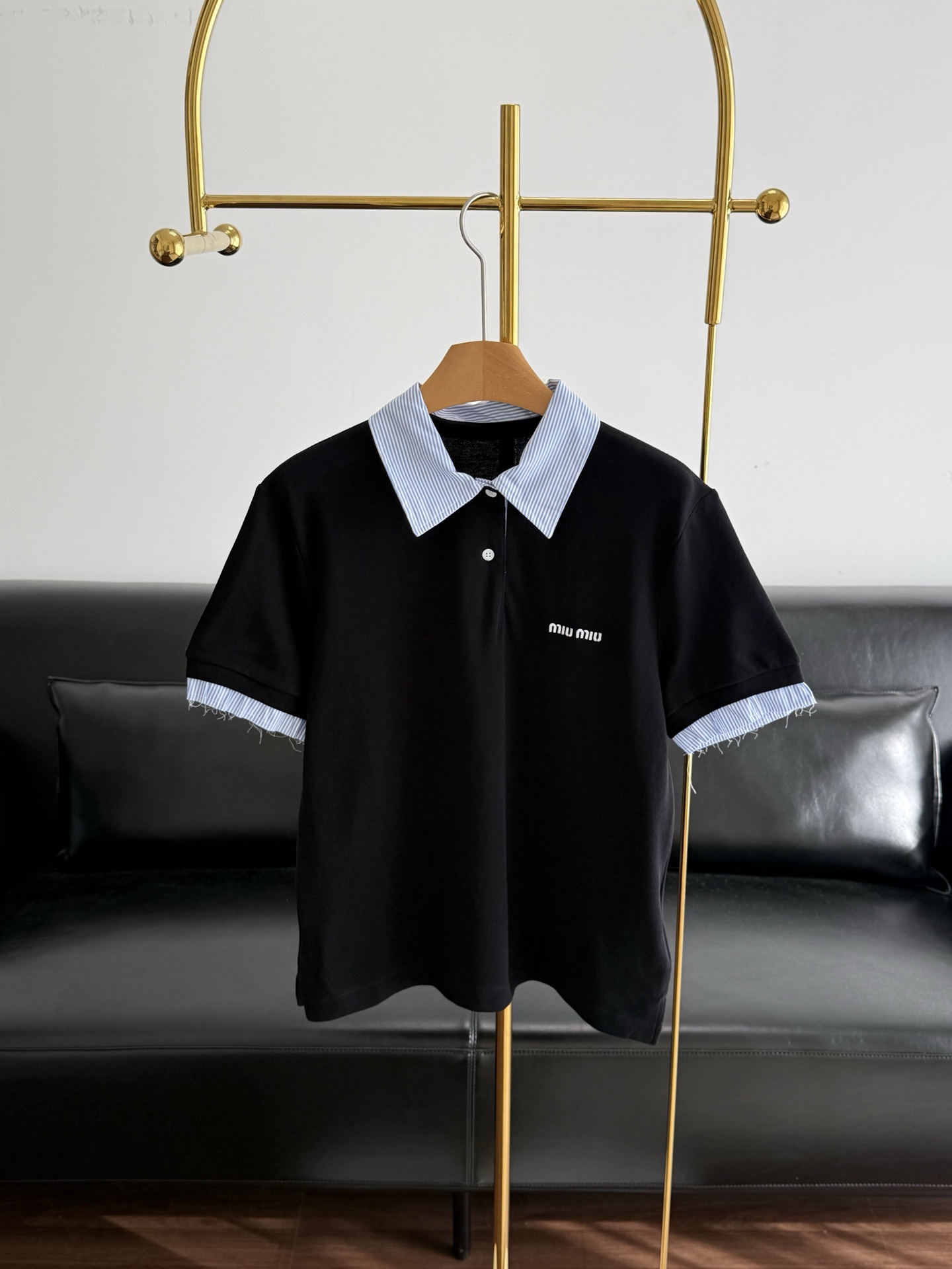 NO:753882,——MiuMiu Same style 26ss new black and white contrasting color Polo shirt, pure cotton fabric!  A well-designed black and white contrasting polo shirt, with a black main body and white lapels and cuffs. It is simple and has a bit of college style and street style. It is also embellished with small letters on the chest. The overall style is versatile without losing details. Whether it is daily commuting, casual outings, or paired with sporty or retro styles, it can be easily worn. It is a practical item in the spring and summer wardrobe. Size SML,,miumiu,19860909——MiuMiu 同款26ss新款黑白撞色Polo衫 纯棉面料！设计感十足的黑白撞色Polo衫,黑色主体搭配白色翻领和袖口,简约中带点学院风与街头感,胸前还有小字母刺绣点缀,整体风格百搭又不失细节.无论是日常通勤、休闲出街,还是搭配运动风或复古造型,它都能轻松驾驭,是春夏衣橱里的实用单品. 尺码SML,,miumiu,,Women's clothing