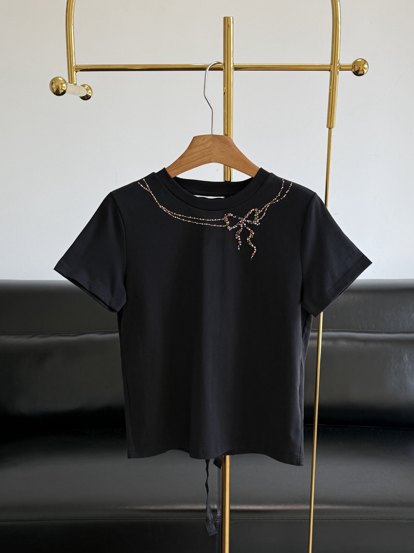 NO:892581,——Miss colored hot rhinestoned back strapped lace short sleeves. Basic round neck + regular version of shoulder short sleeves. Clean lines, loose and moderate tailoring. Not picky about body shapes. Very tolerant of various body types. Cotton fabric with good drape. The upper body is comfortable and breathable and not easy to collapse and deform. The bow part is matched with colorful rhinestones. The strapped lace on the back is slightly sexy. It is particularly eye-catching against the black body and breaks the monotony of a pure black T-shirt.  It has an exquisite light luxury atmosphere. The overall design is simple yet refined, and the details are very bright!  Code number sml,,T-shirt,19860909——Miss彩色烫钻后绑带蕾丝短袖 基础圆领 + 正肩短袖的常规版型 线条利落,剪裁宽松适中 不挑身材 对各种体型的包容度很高 垂坠感不错的棉质面料 上身舒适透气 也不容易软塌变形 蝴蝶结部分搭配了彩色的水钻设计 后背绑带蕾丝 隐隐微露的性感 在黑色衣身的衬托下格外亮眼 打破了纯黑 T 恤的单调感 自带精致的轻奢氛围 整体设计简约又不失精致感,细节很有亮点！ 码数sml,,T-shirt,,Women's clothing