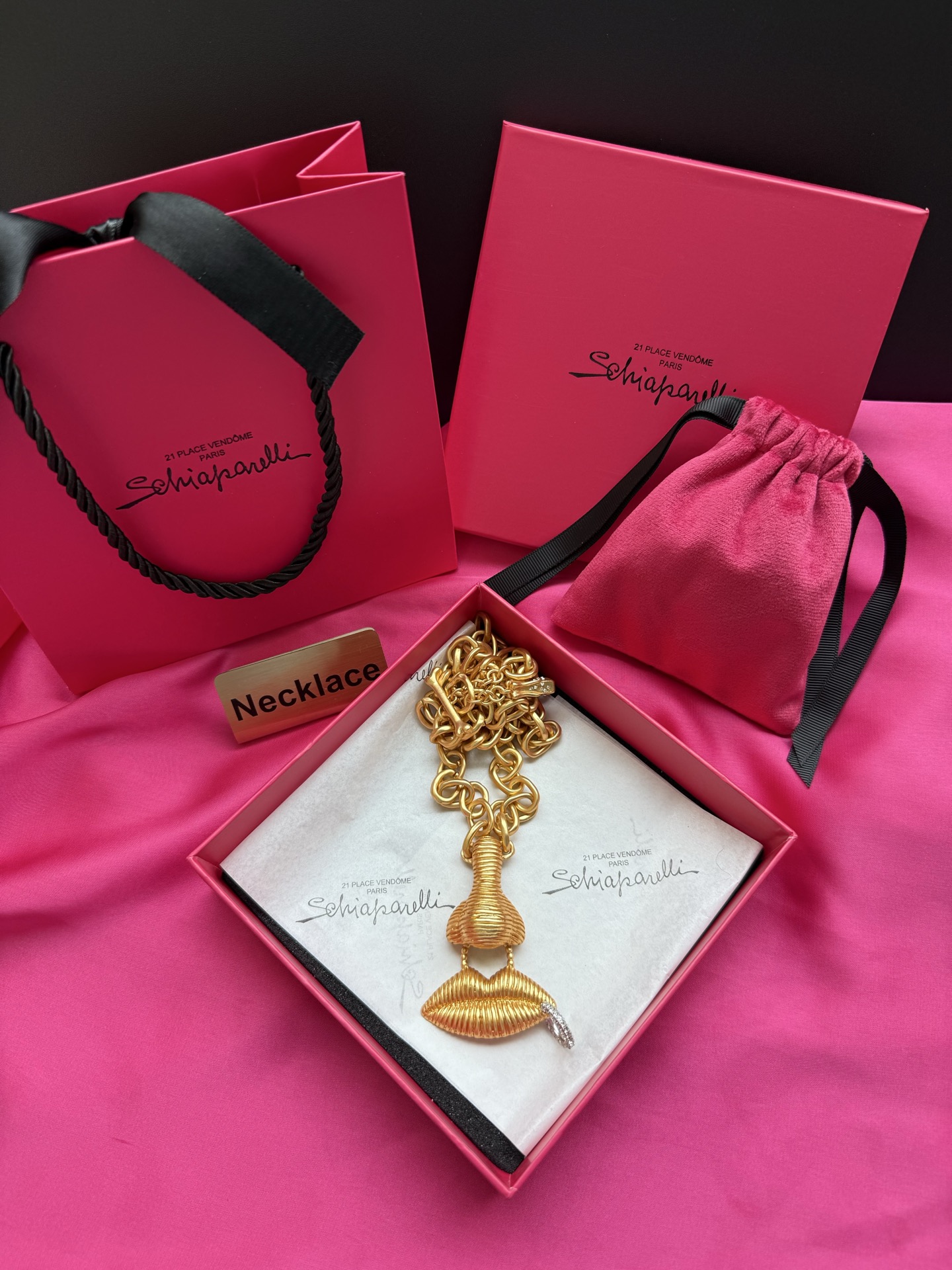 Золотистое колье с подвеской в виде губ Schiaparelli
