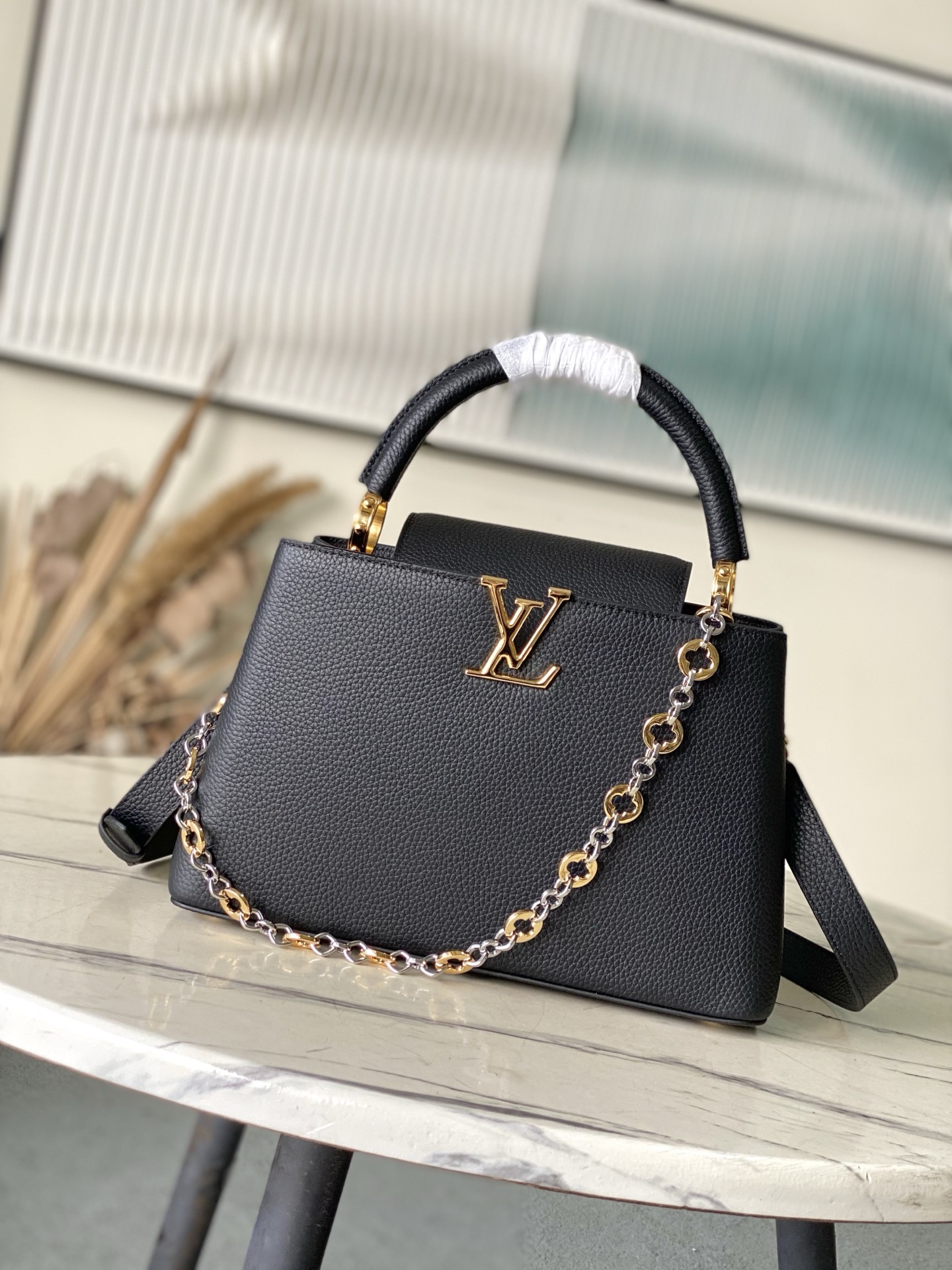 特级原厂皮 M12936 黑色中号 本款Capucines中号手袋出自Chain On You系列，以T