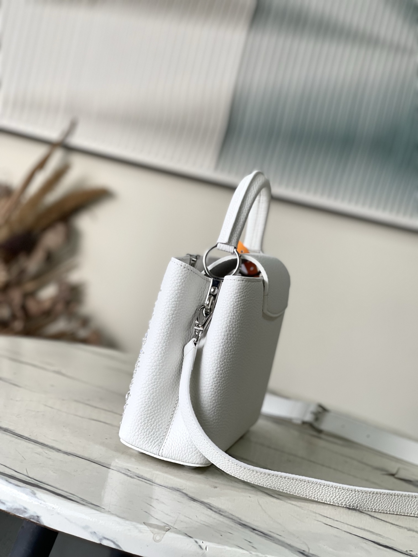 特级原厂皮 M25934 白色小号 作为“非凡系列”的一部分，这款卡普尼迷你包重新设计，采用了精致的刺绣