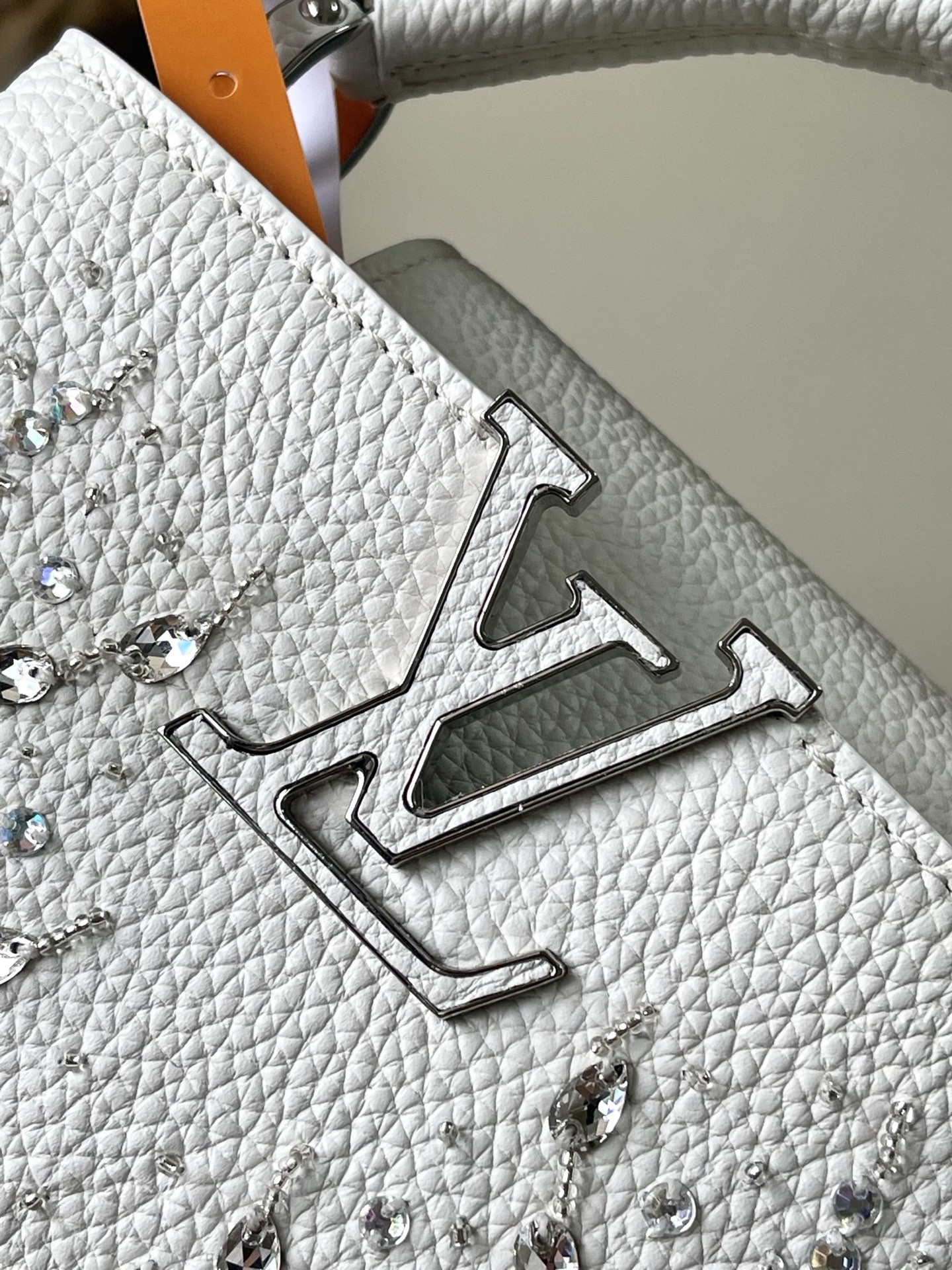 特级原厂皮 M25934 白色迷你 作为“非凡系列”的一部分，这款卡普尼迷你包重新设计，采用了精致的刺绣