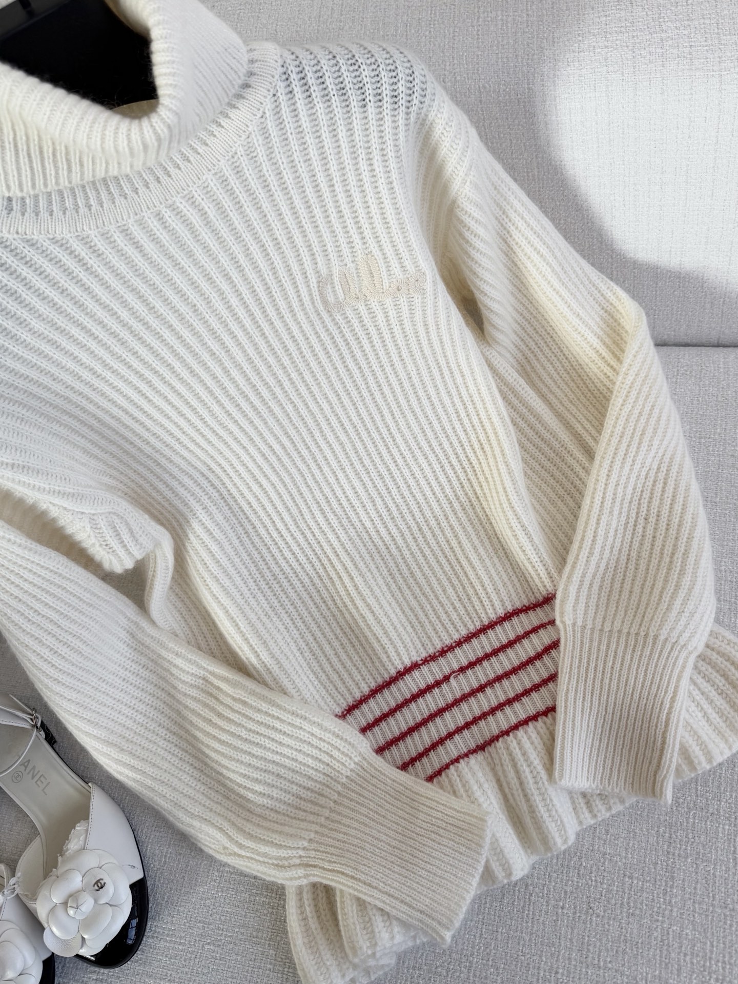 Elegant Cream White Turtleneck Sweater with Ruffle Hem and Red Stripe