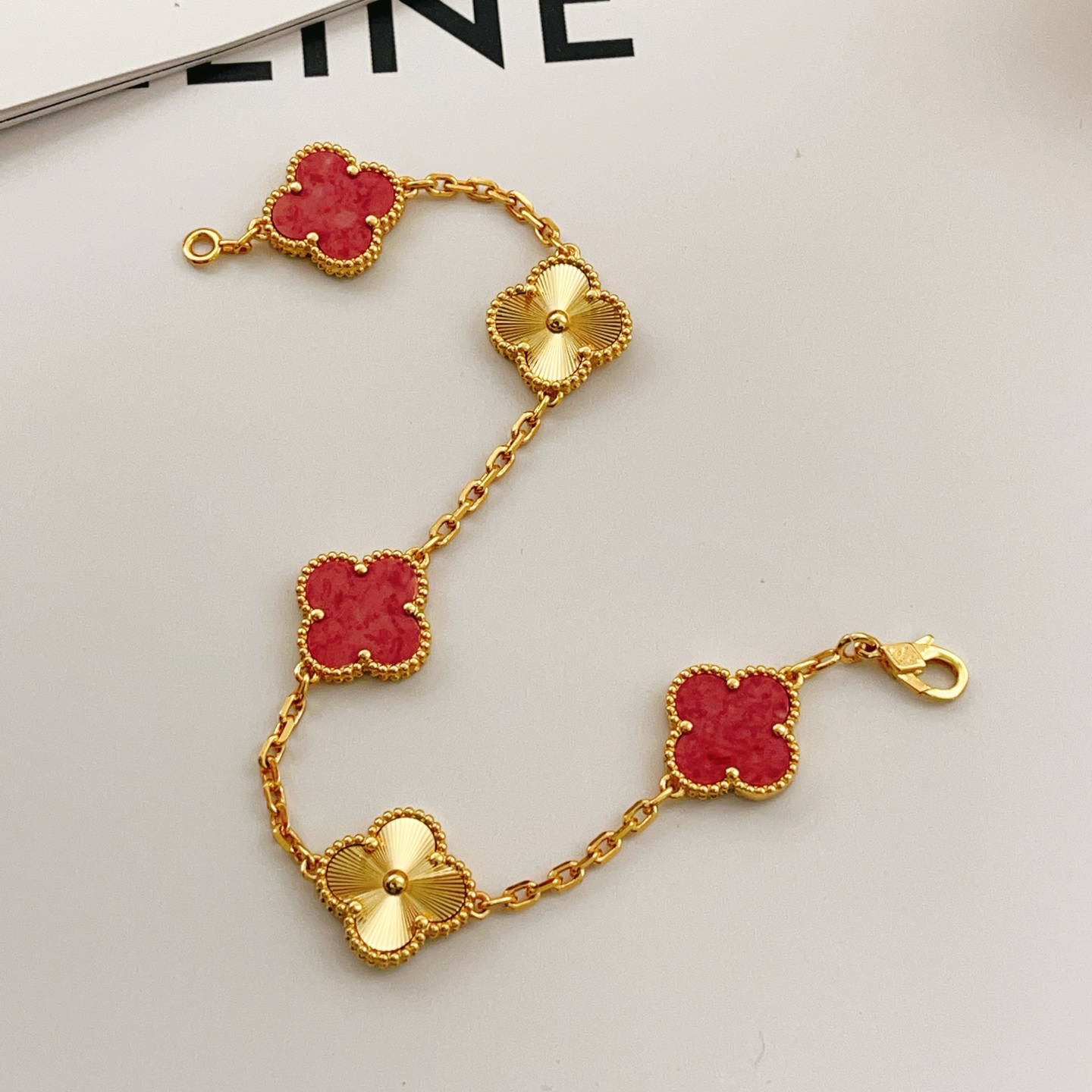 Van Cleef Arpels Vintage Alhambra bracelet Yellow gold with red stone inlays and guilloche gold motifs 18cm