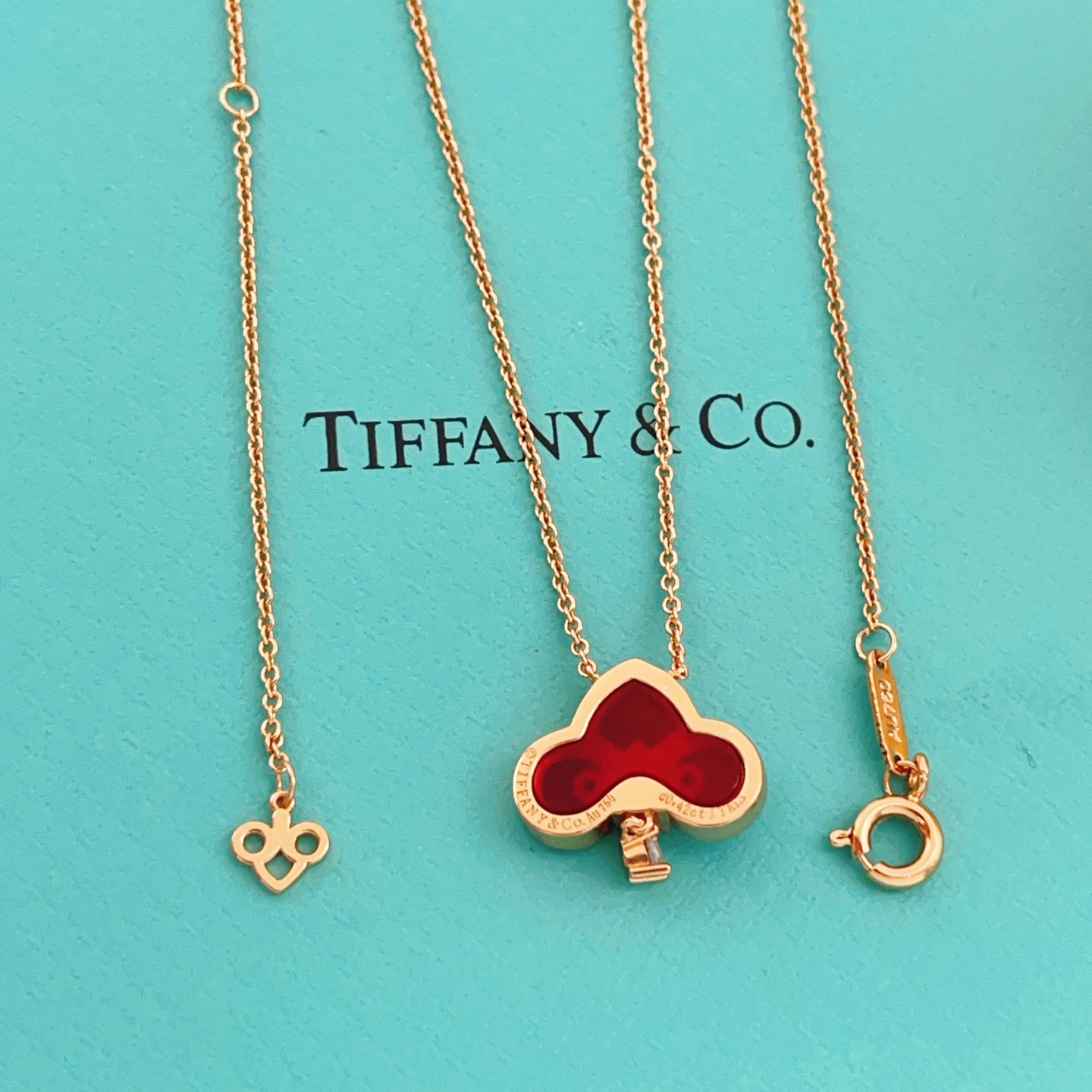 Tiffany Co Fleur de Lis Key Pendant Necklace necklace Rose gold metal with red carnelian inlay and clear diamond accents 45cm