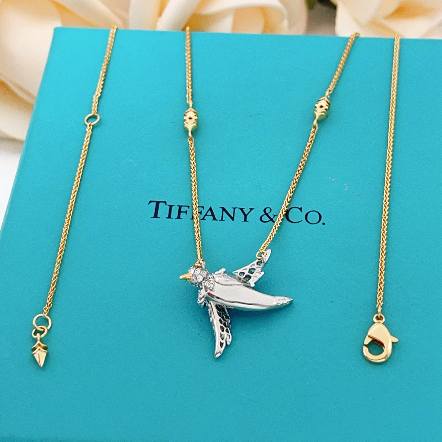 Tiffany Co Bird on a Point necklace Two-tone yellow gold and platinum-plated metal clear pave diamonds blue sapphire eye 18 inches